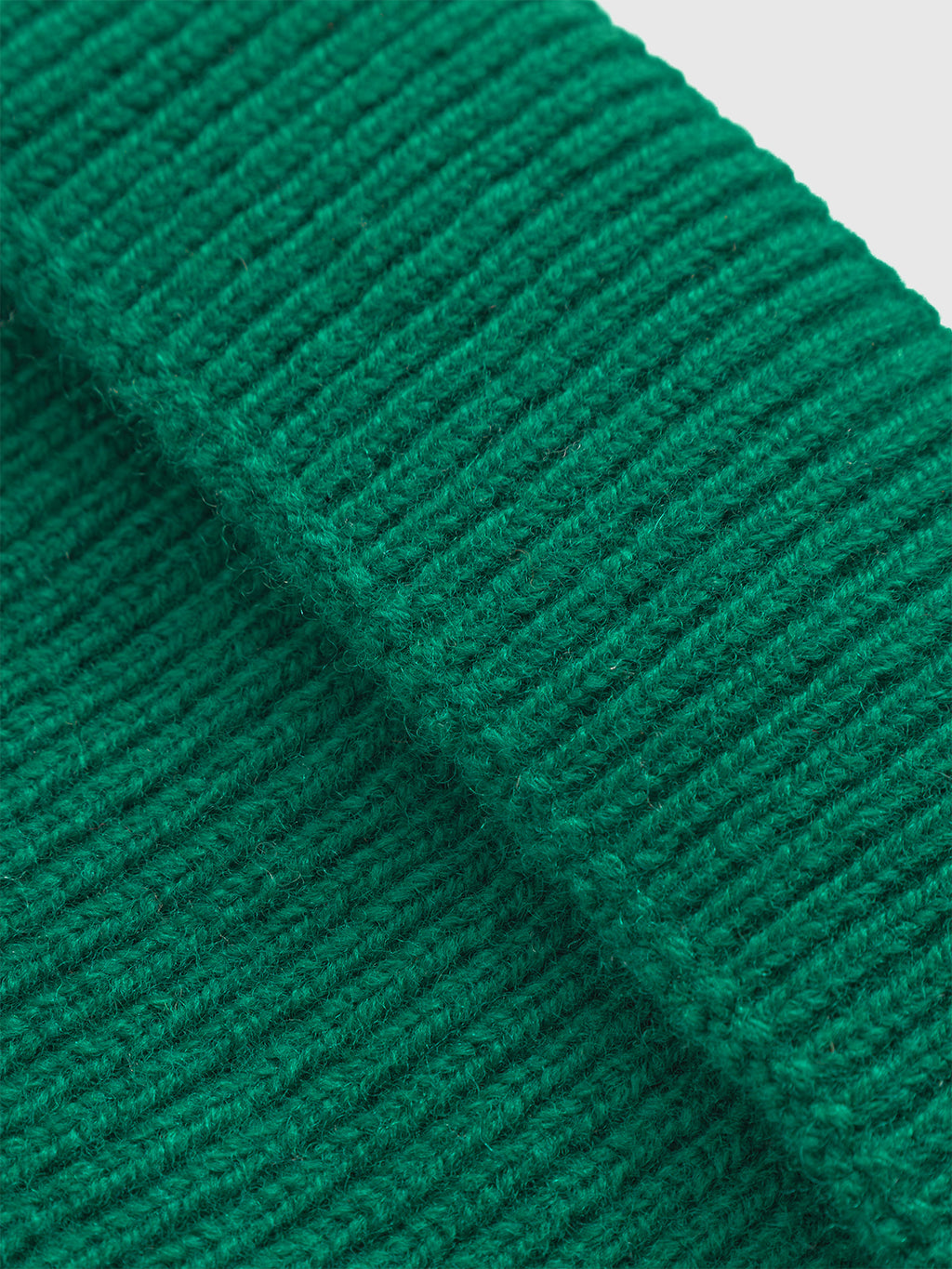 Close-up of Biella Aico - Green ribbed knit fabric by Gabba, highlighting its textured and tightly woven design—ideal for a cozy merino wool beanie.