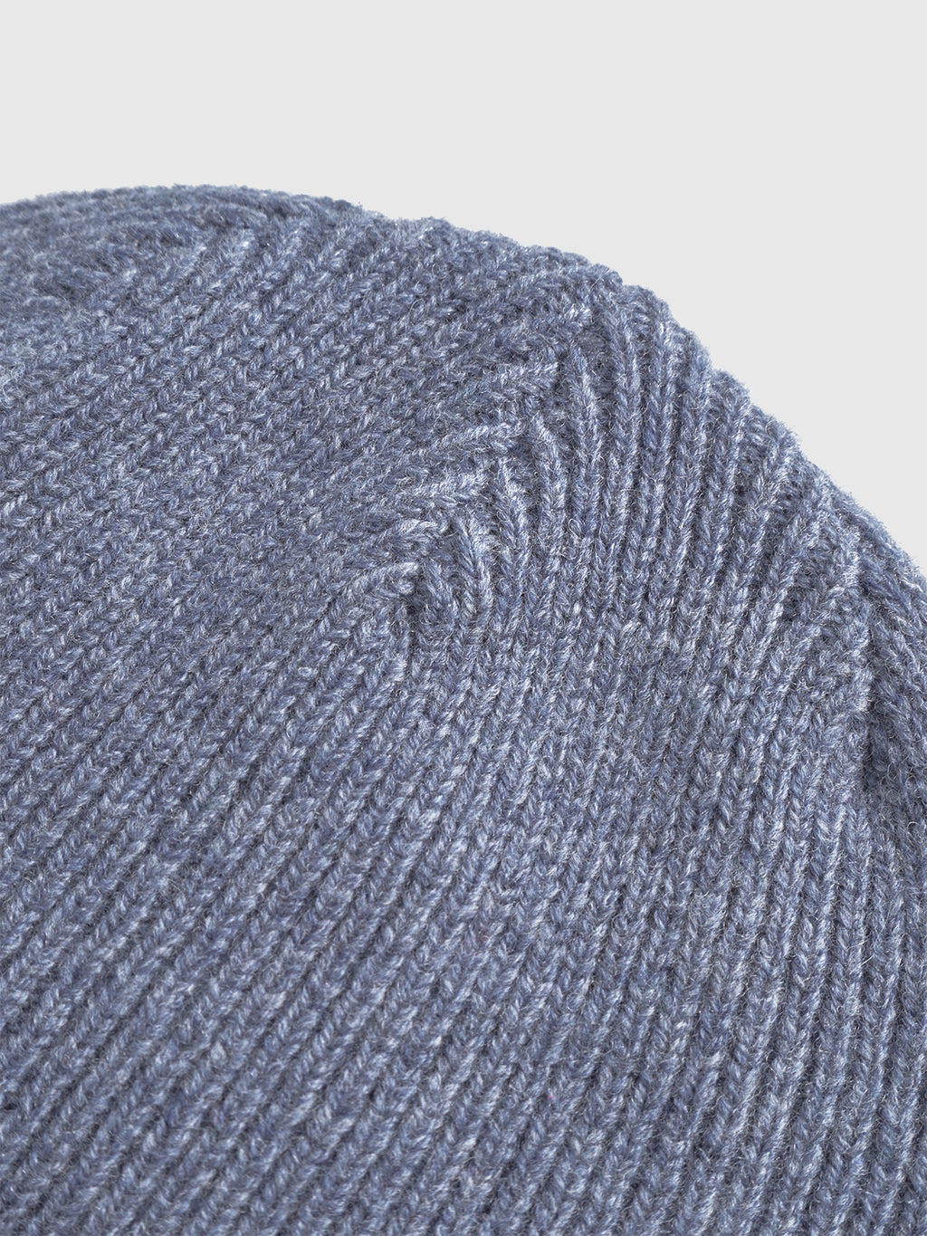 Close-up of the Gabba Biella Aico beanie in vintage indigo, highlighting its detailed ribbed knit texture and precise edge stitching.
