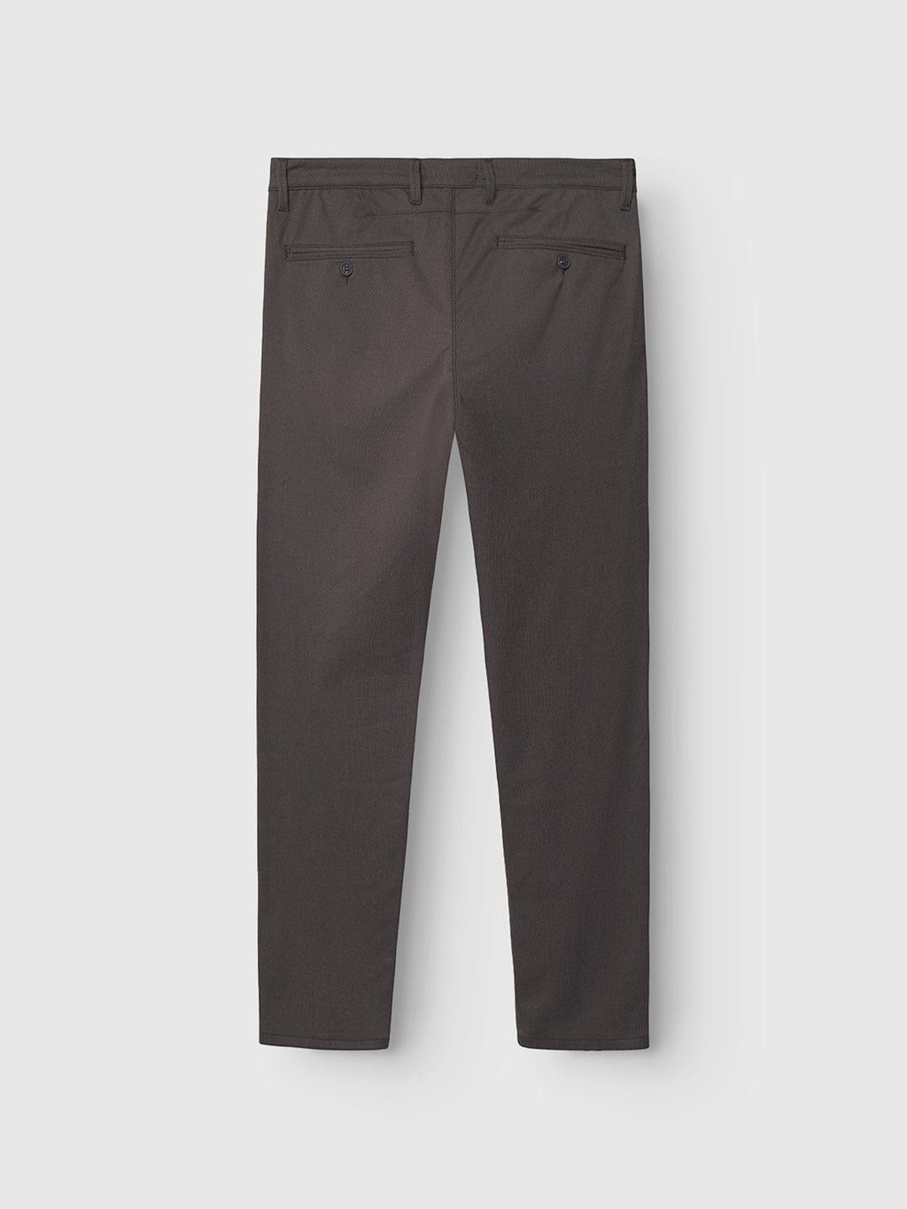 Back view of Gabba’s Paul Domo slim chino pant in dark brown, featuring French pockets, two buttoned back pockets, and a modern slim leg opening. Shown against a light gray background.