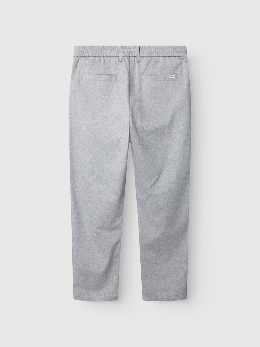Back view of Gabba’s Napoli 19 Carre pants in light grey, featuring a timeless design, elastic waistband, two back welt pockets, and a small white tag above the right pocket, shown on a plain white background.