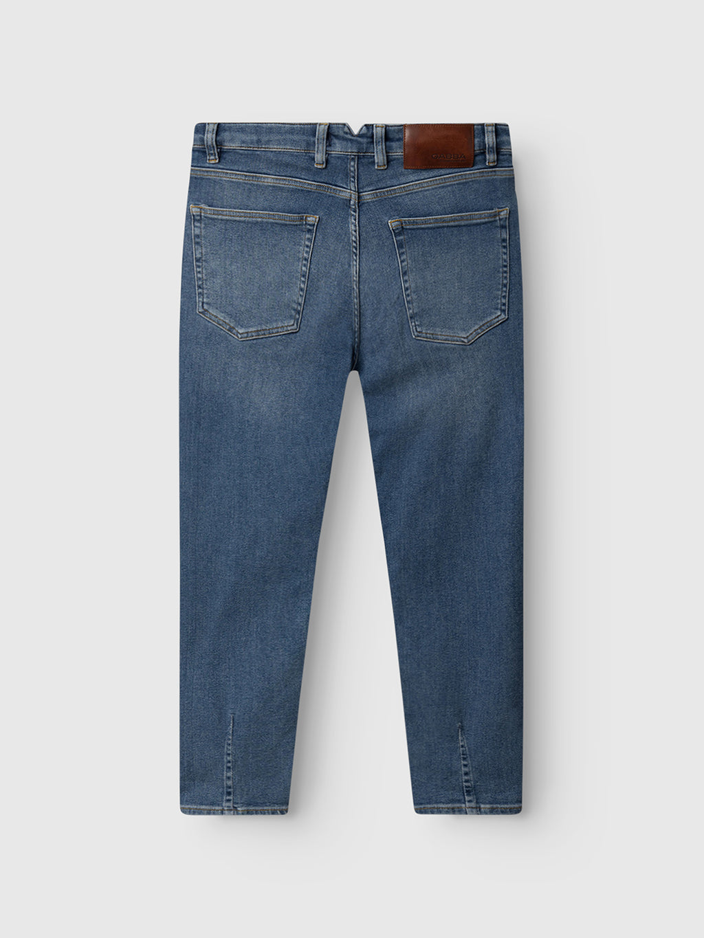 The GABBA Alex K3948 Jeans in denim wash are displayed from the back, showing two rear pockets, belt loops, contrast stitching, and a brown leather patch on the waistband, laid flat on a light gray background.