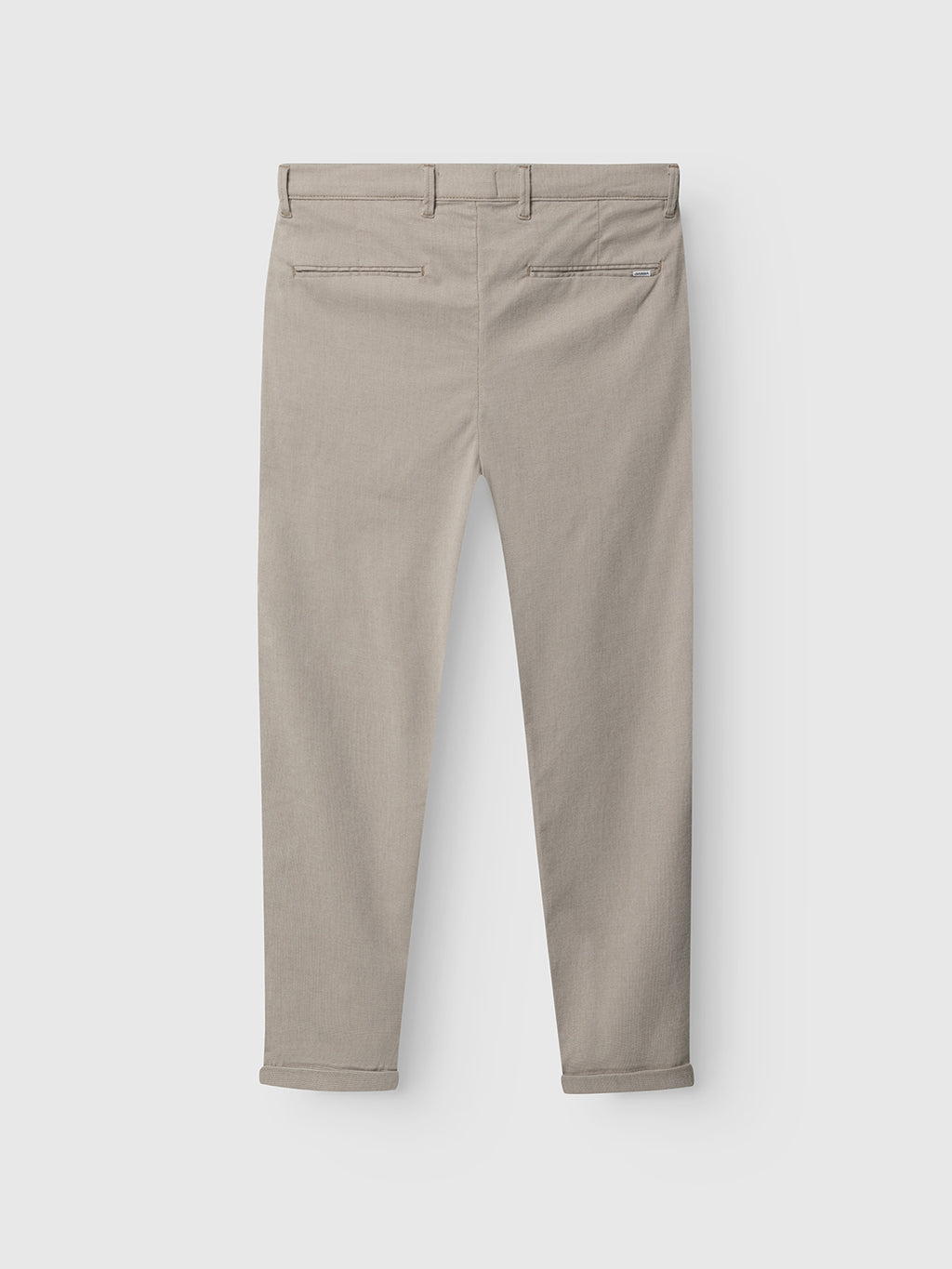 Gabba Pisa Domo Pants in Coriander displayed from the back, with two welt pockets and rolled cuffs, laid flat on a white background—showcasing timeless style and versatility.