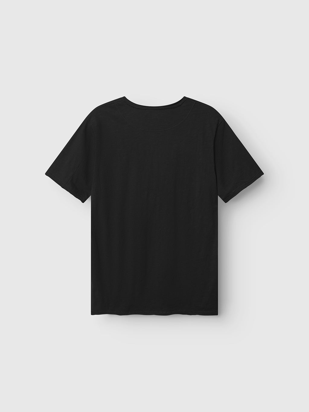 The Gabba GABkostant New SS - Meteorite, a plain black short-sleeve textured t-shirt, is shown from the back against a light gray background with no visible logos or designs.