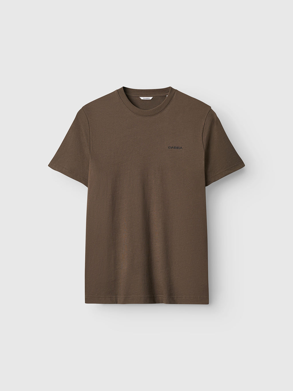 The Gabba GABdune Logo GOTS SS T-Shirt in Crocodile is a classic fit brown tee featuring a small logo on the left chest, made from GOTS-certified organic cotton, shown on a light gray background.