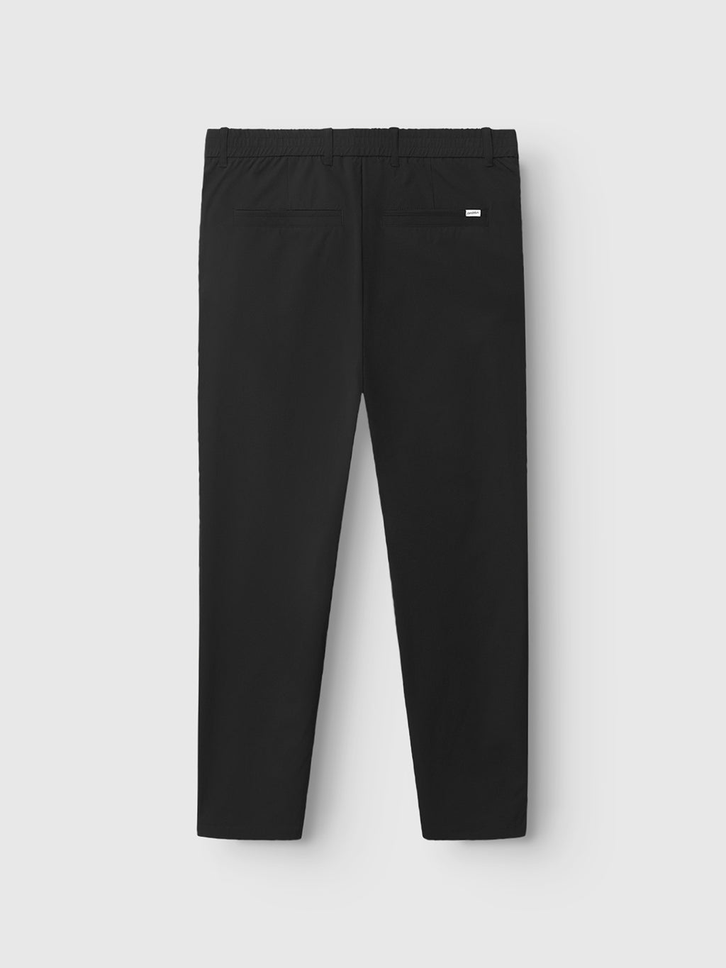 The Gabba GABmonza Tech - Black relaxed straight fit pants are shown from the back with two back pockets and a small white label above the right pocket, displayed against a plain white background.