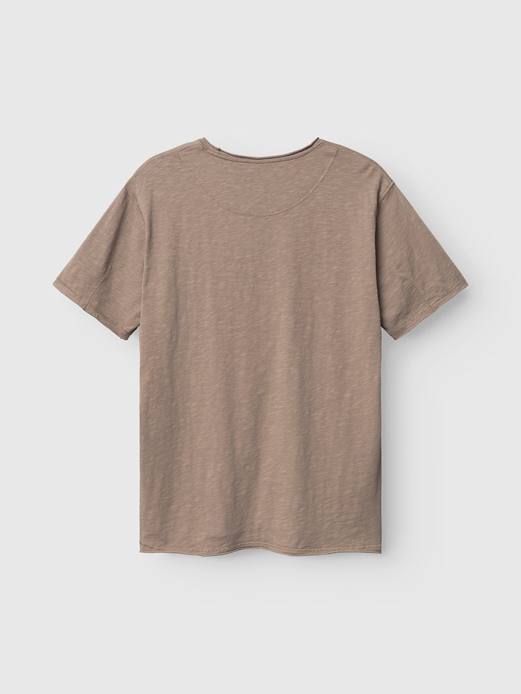 The Gabba GABkostant New SS - Fungi t-shirt, featuring short sleeves and light brown slub fabric, is laid flat with the back side up against a white background.