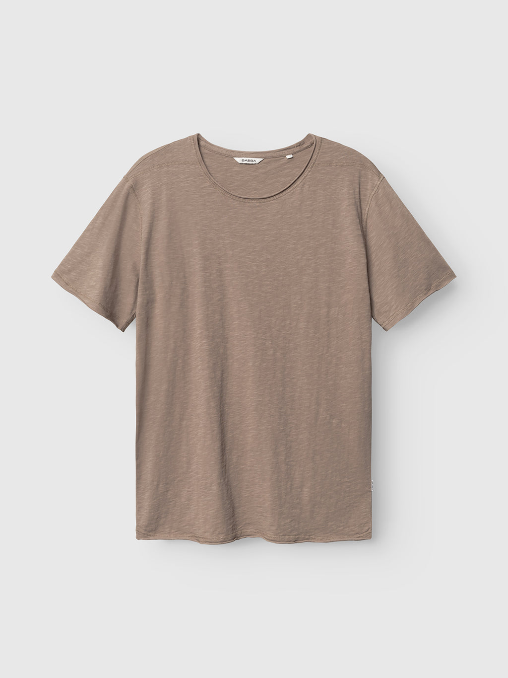 The Gabba GABkostant New SS - Fungi t-shirt, featuring short sleeves and a round neckline in light brown slub fabric, is shown against a light grey background, highlighting its simple, casual design with a subtle textured look.
