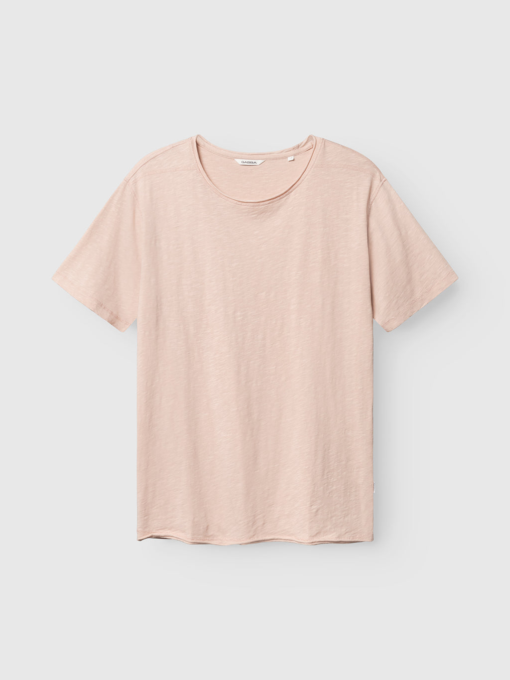 The Gabba GABkostant New SS t-shirt in Misty Rose features short sleeves, a round neckline, and slub-textured 100% cotton. It’s displayed against a light gray background.