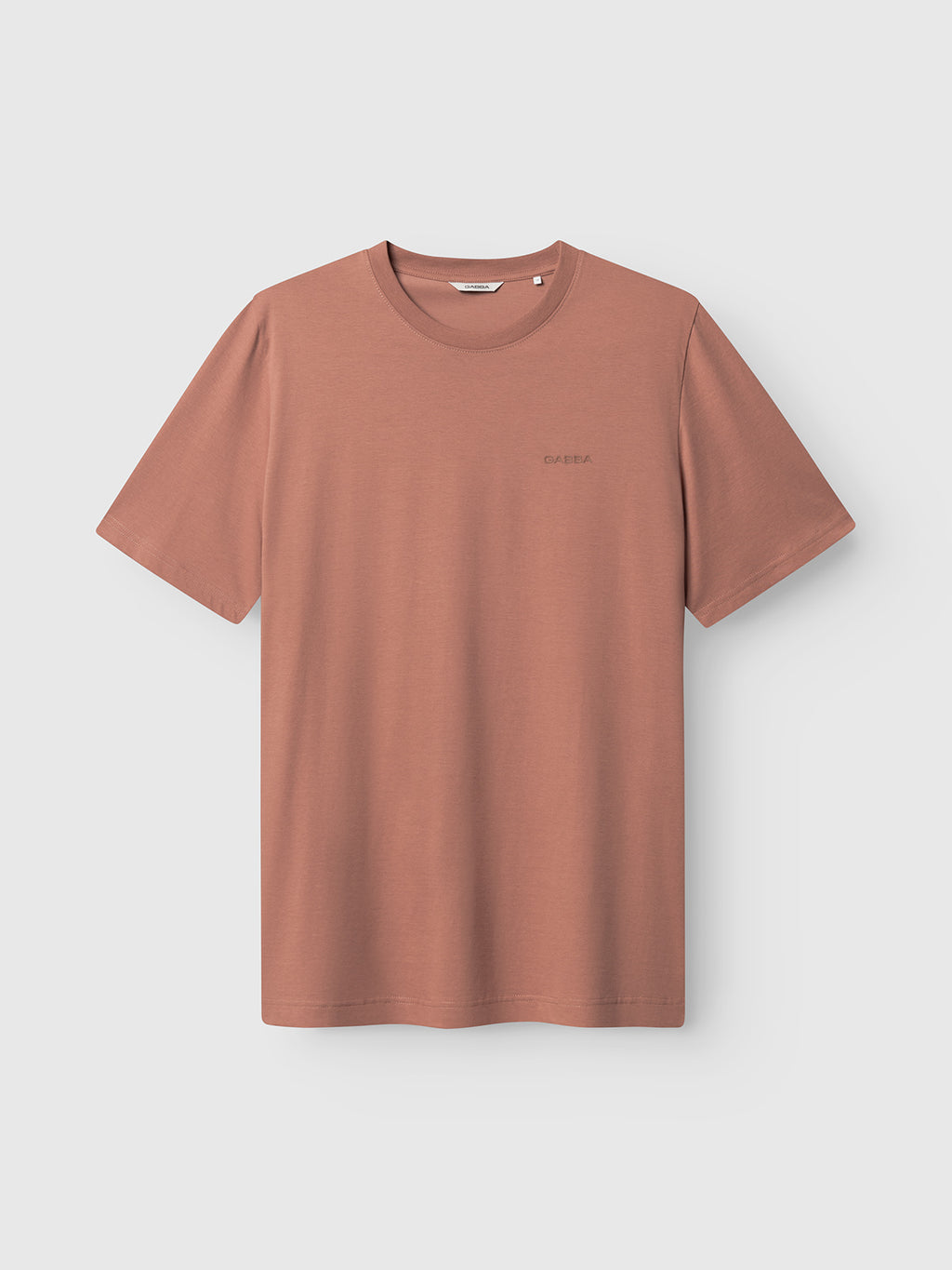 The Gabba GABdune Logo GOTS SS T-Shirt in Wood Pink is a classic fit, short-sleeved crew neck tee featuring a subtle left chest logo, shown against a light gray background.