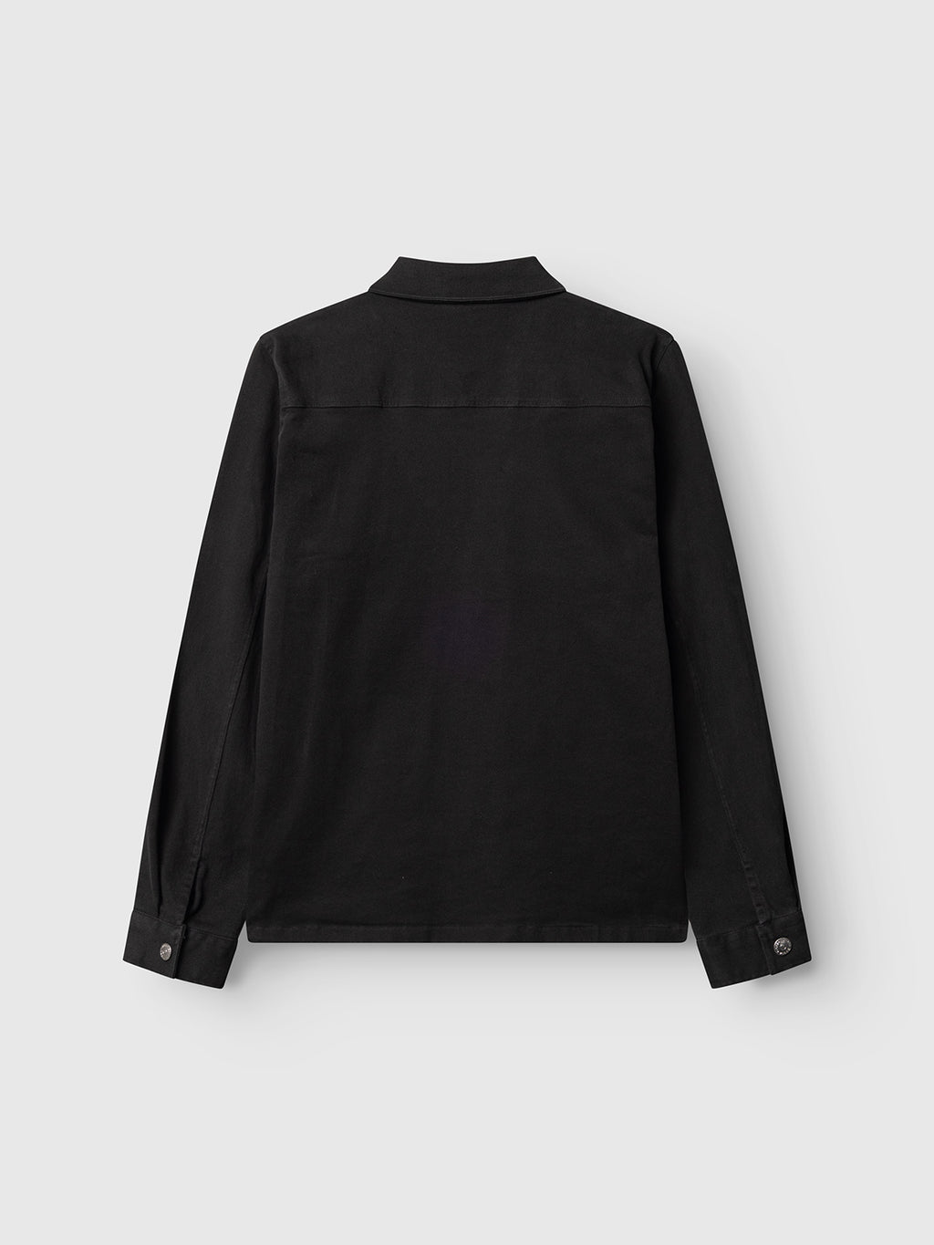 The Gabba GABbeta Twill black long-sleeve workwear overshirt is shown from the back, with a collar and two cuff buttons, crafted from garment-dyed twill and displayed on a plain light gray background.