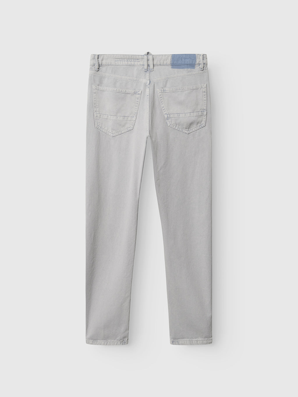Back view of Gabba GABcarl Antiq Jeans in denim blue, featuring two back pockets, belt loops, and a blue waistband patch. Made from rigid twill fabric, these relaxed tapered jeans are an everyday essential shown laid flat on white.