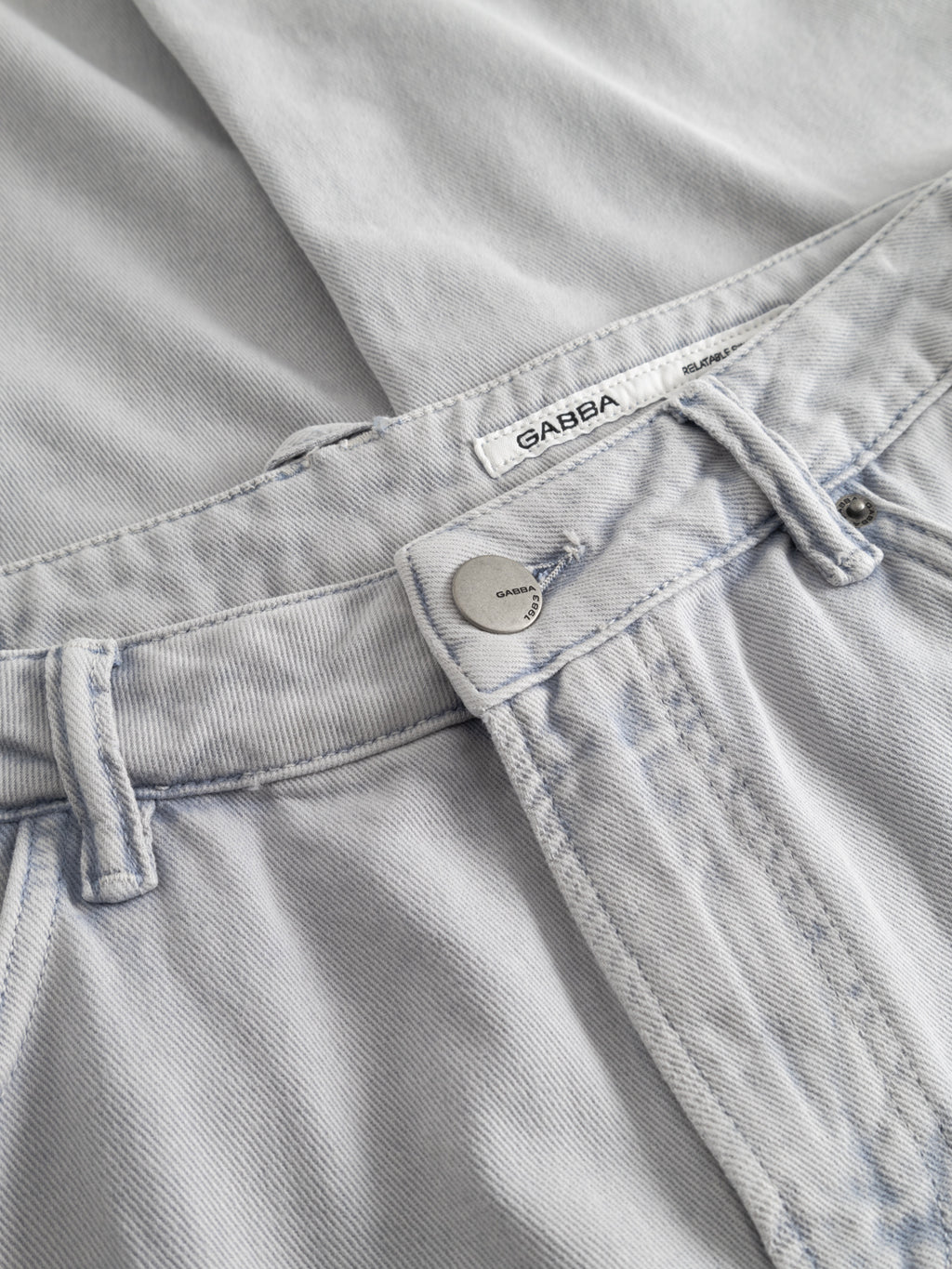GABcarl Antiq Jeans by Gabba in denim blue, made from rigid twill with a visible button, belt loops, and white Gabba label at the waistband—an essential everyday style.