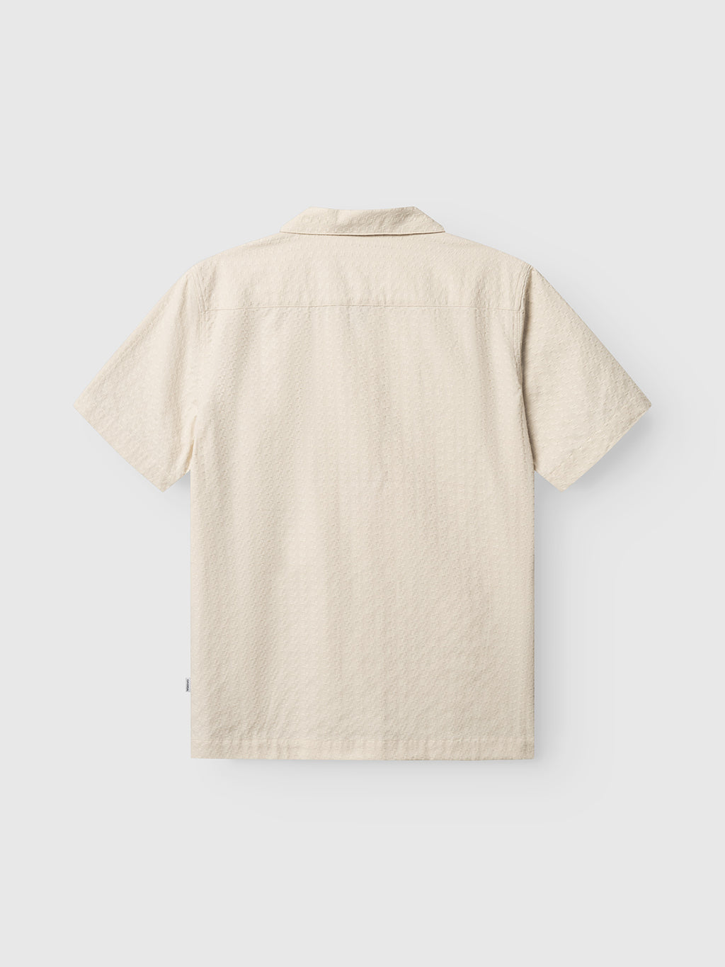 The Gabba GABtimo Resort Neal SS Shirt in Birch is shown flat, back side up, highlighting its subtle jacquard 3D pattern, straight hem, and classic collar. Lightweight fabric lends this short-sleeve shirt a relaxed, casual feel.