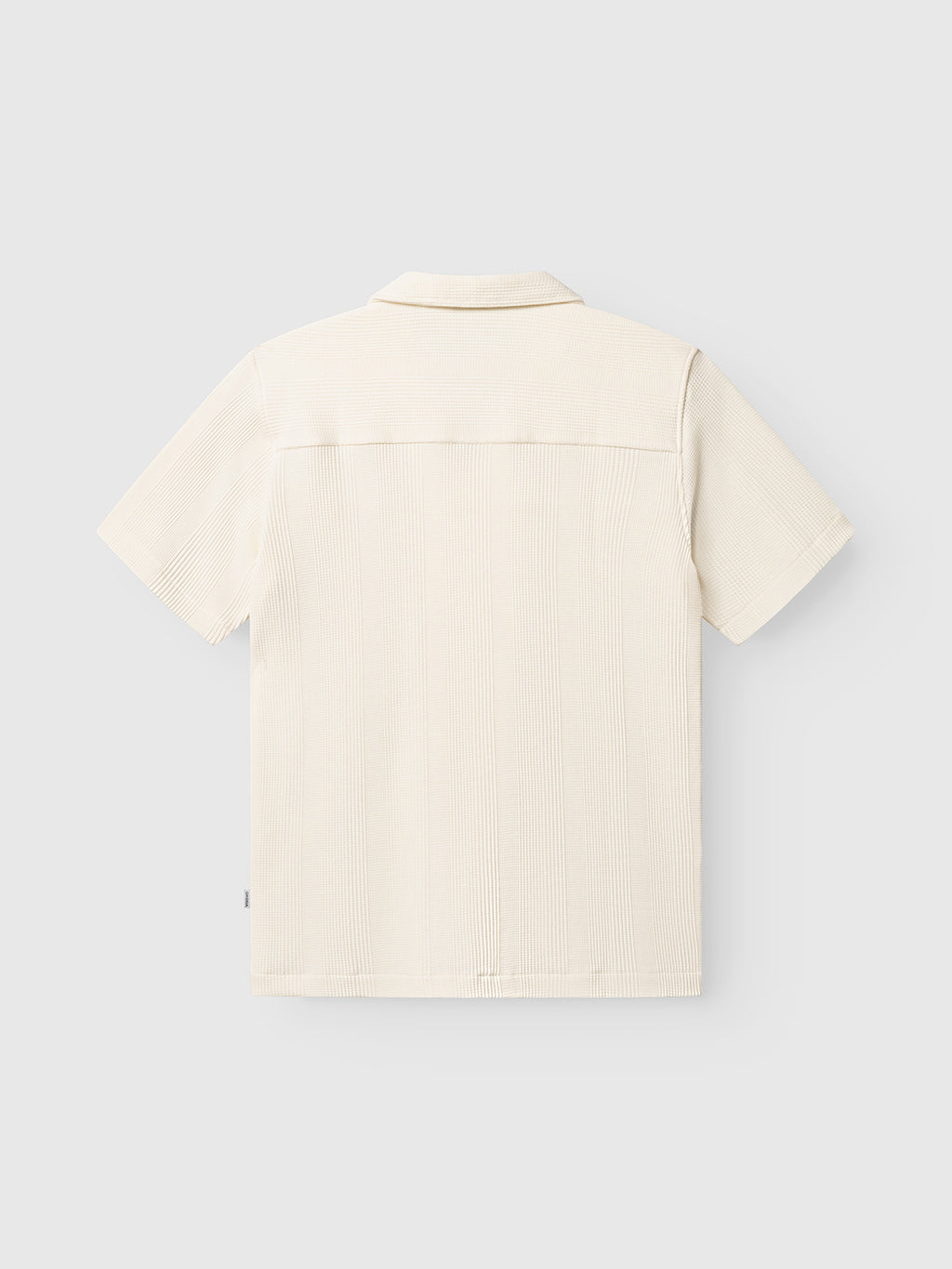 Back view of the Gabba GABvalente Wup SS T-Shirt in Bone White, featuring a relaxed fit and waffle texture with a resort collar, displayed against a plain light gray background.