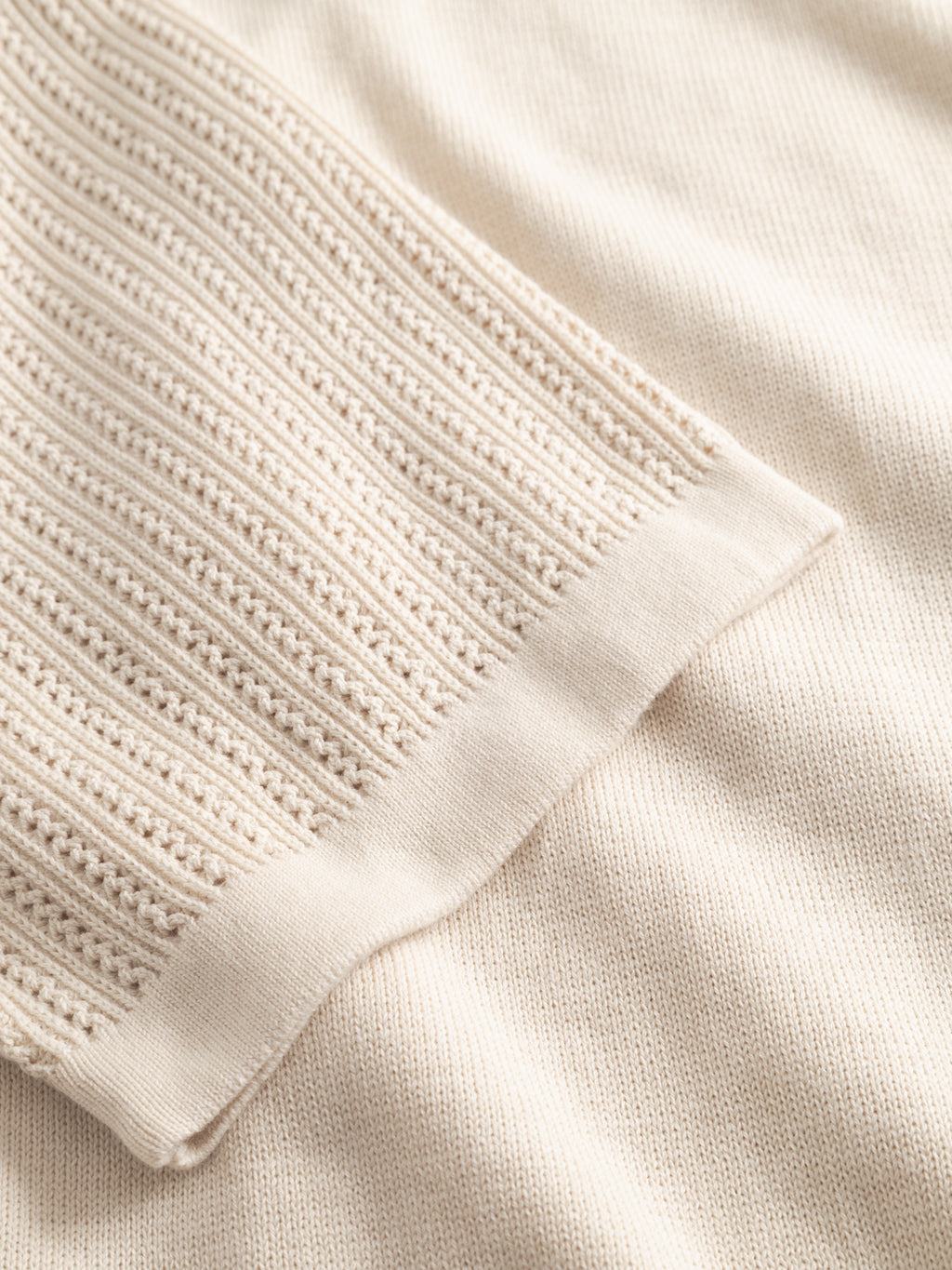 Close-up of the Gabba GABgeno Resort Bride SS Knit in Birch, showing the ribbed sleeve texture and smoother knit on the main body.