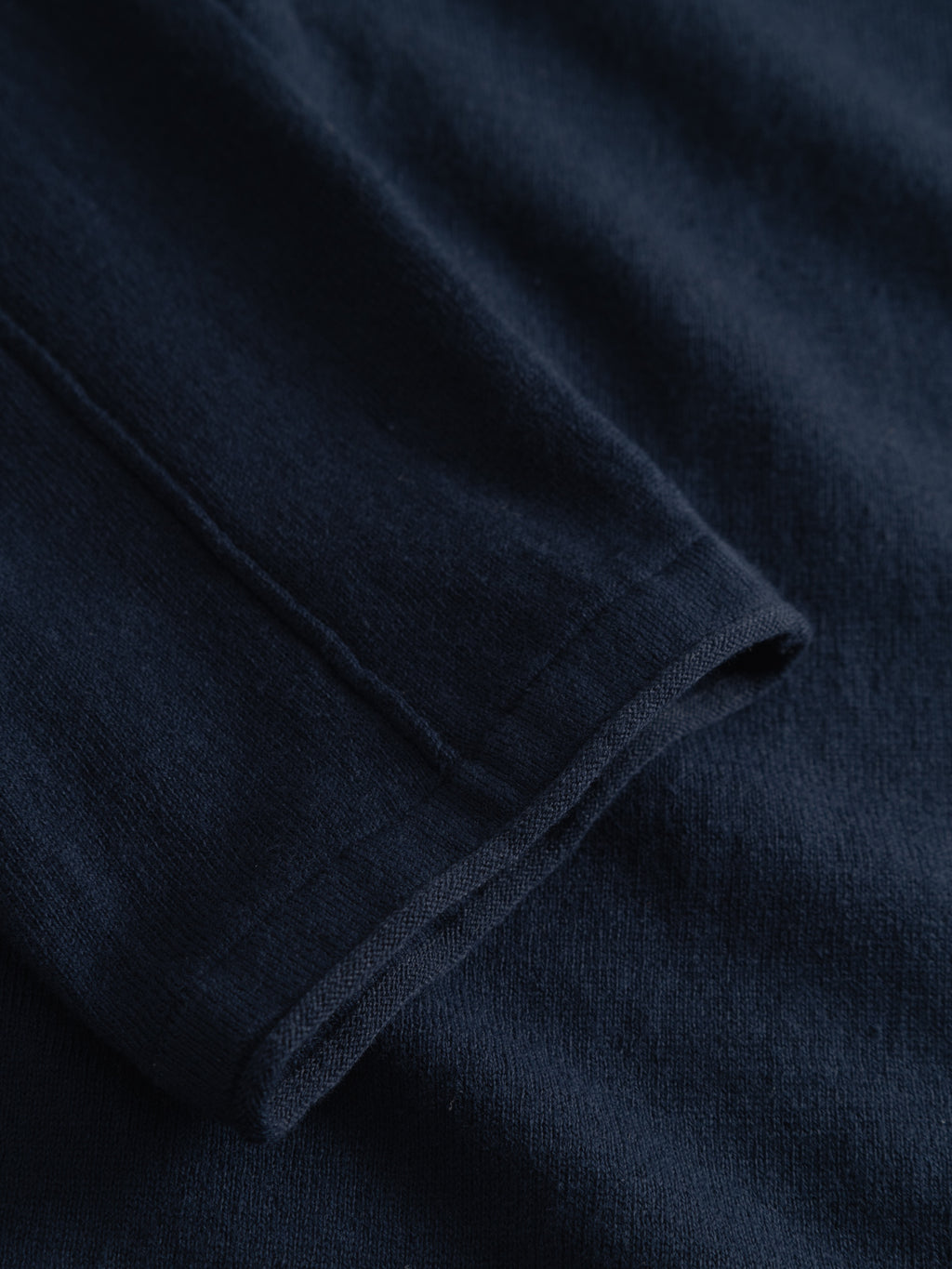 Close-up of the Gabba GABlima Cot LS Knit - Navy, highlighting the sleeve and fabric's soft, slightly ribbed texture, seamless detailing, and regular fit.