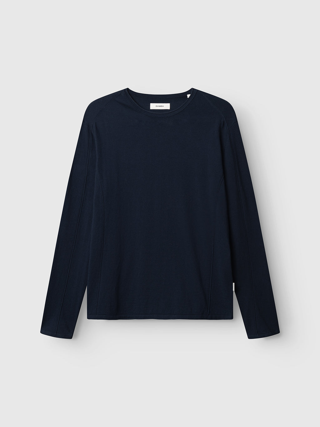 The Gabba GABlima Cot LS Knit - Navy is a plain, regular-fit long-sleeve shirt with a crew neckline, made from breathable cotton. It’s displayed against a light gray background and features no patterns, logos, or buttons.