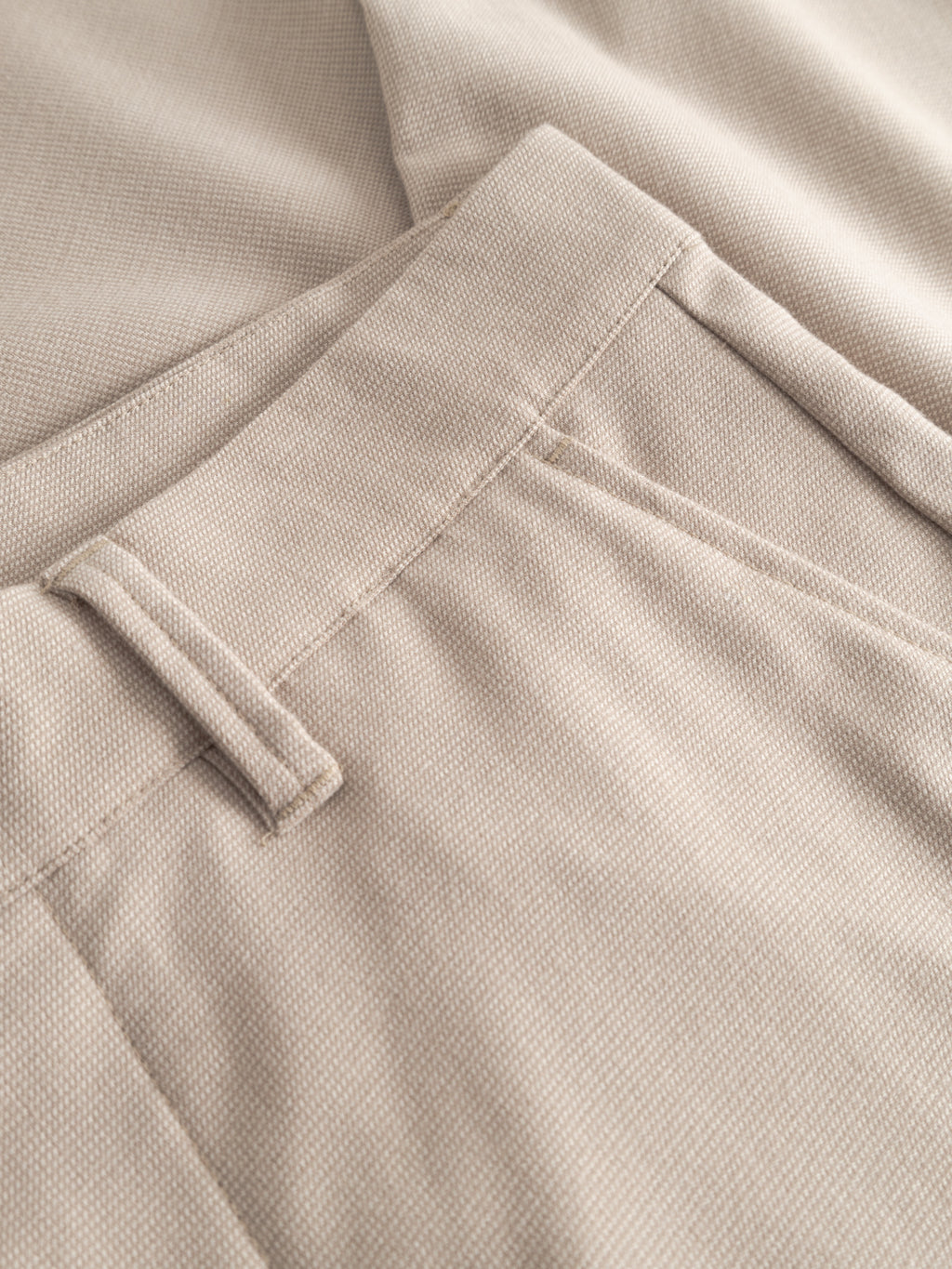 Close-up of the Gabba GABpaul Deme Pant - Birch, showcasing the slim-fit waistband, belt loop, pocket details, and micro-pattern woven fabric.