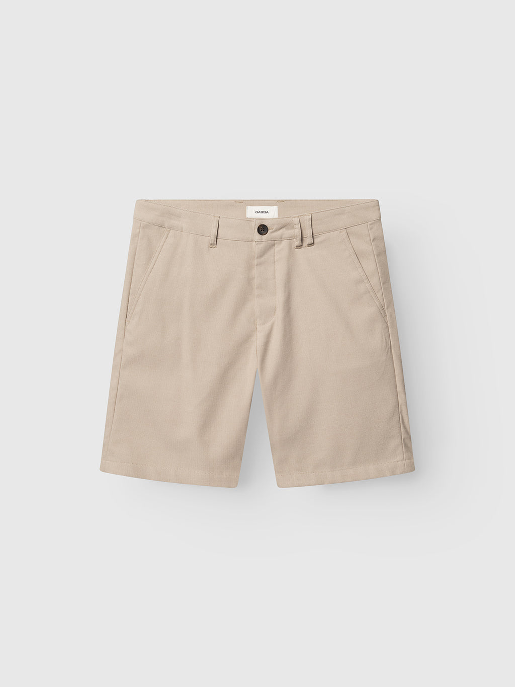 The Gabba GABjet Deme Shorts in Birch are beige slim-fit chino shorts with belt loops, front pockets, and a button closure, featuring a classic chino design and shown flat on a white background.