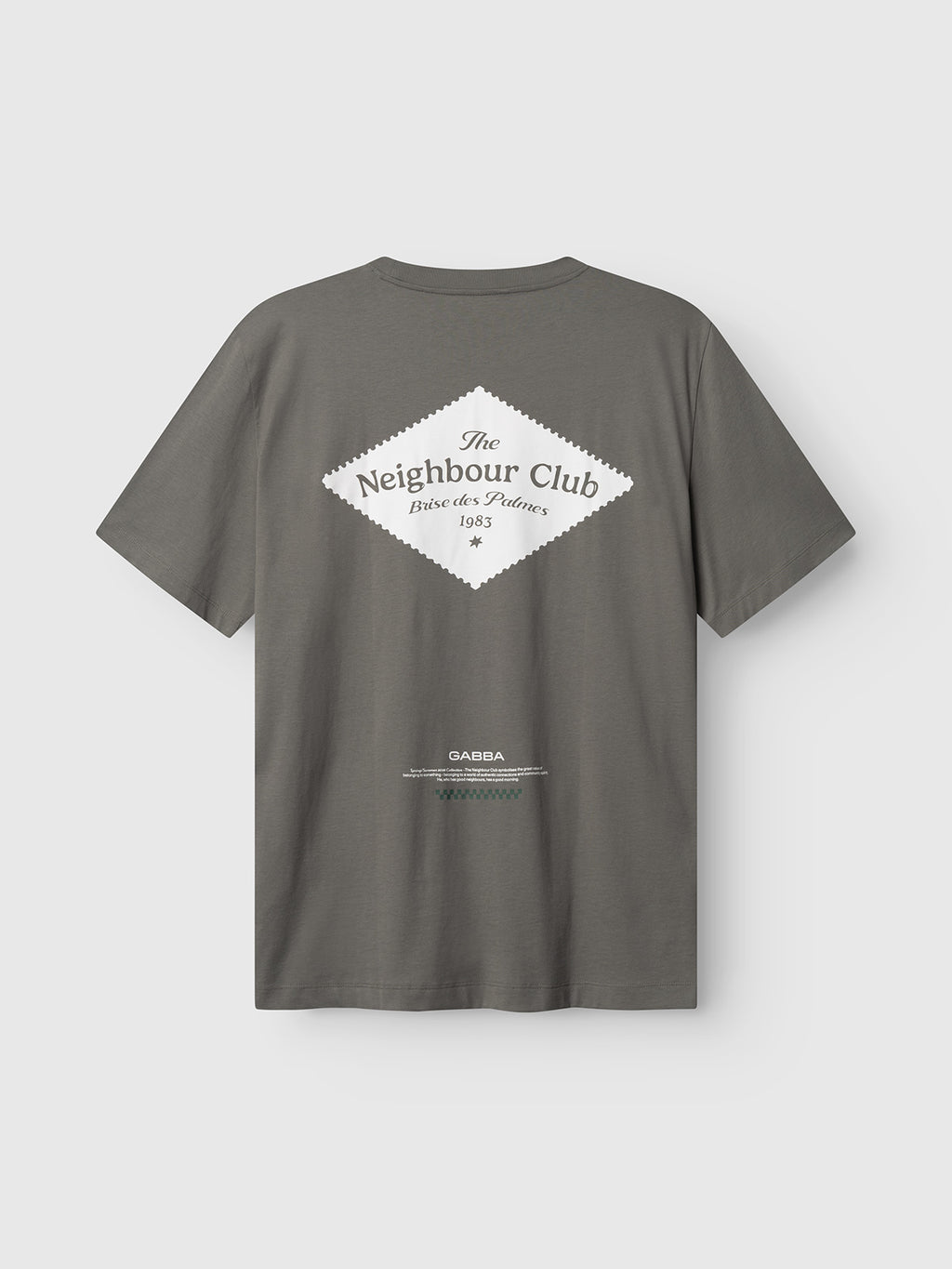 The Gabba GABnigel Boxy NBH SS T-shirt in Castor Gray is an oversized organic cotton tee featuring a bold white diamond-shaped “The Neighbour Club, Builders & Painters 1985” print on the back, plus extra small text and logos underneath.