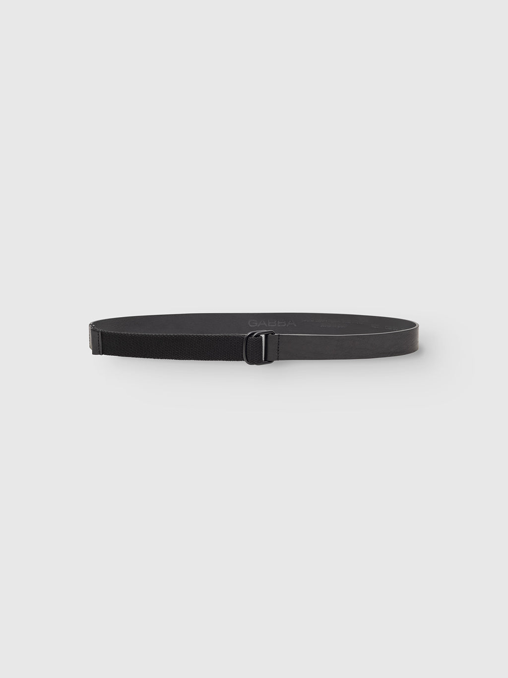 The Gabba GABmixme Belt - Black is a modern leather belt with a rectangular buckle, showcased in a circular form on a plain light gray background.
