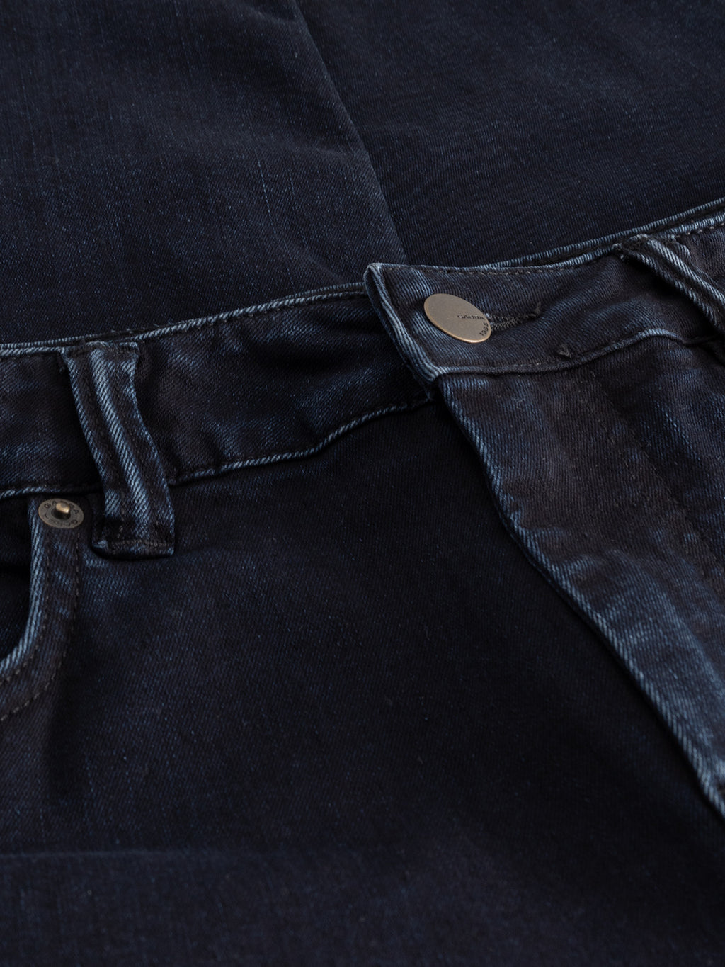 Close-up of Gabba's GABjones BlueBlack denim jeans in blue black, showcasing a slim straight fit with detailed waistband, button, belt loops, and front pocket stitching. Slight seam fading highlights the fabric’s flexibility and premium texture.