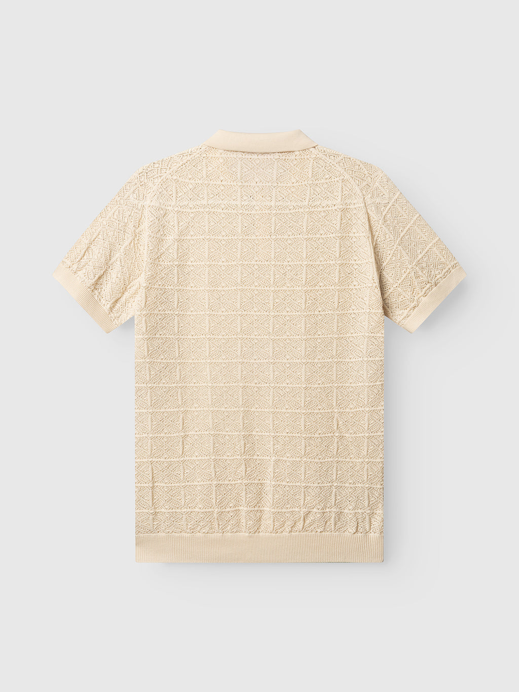The Gabba GABbenson Fiwi SS polo in Birch is shown from the back, highlighting its open hand-knit grid pattern and ribbed cuffs, hem, and collar, set against a light gray background.