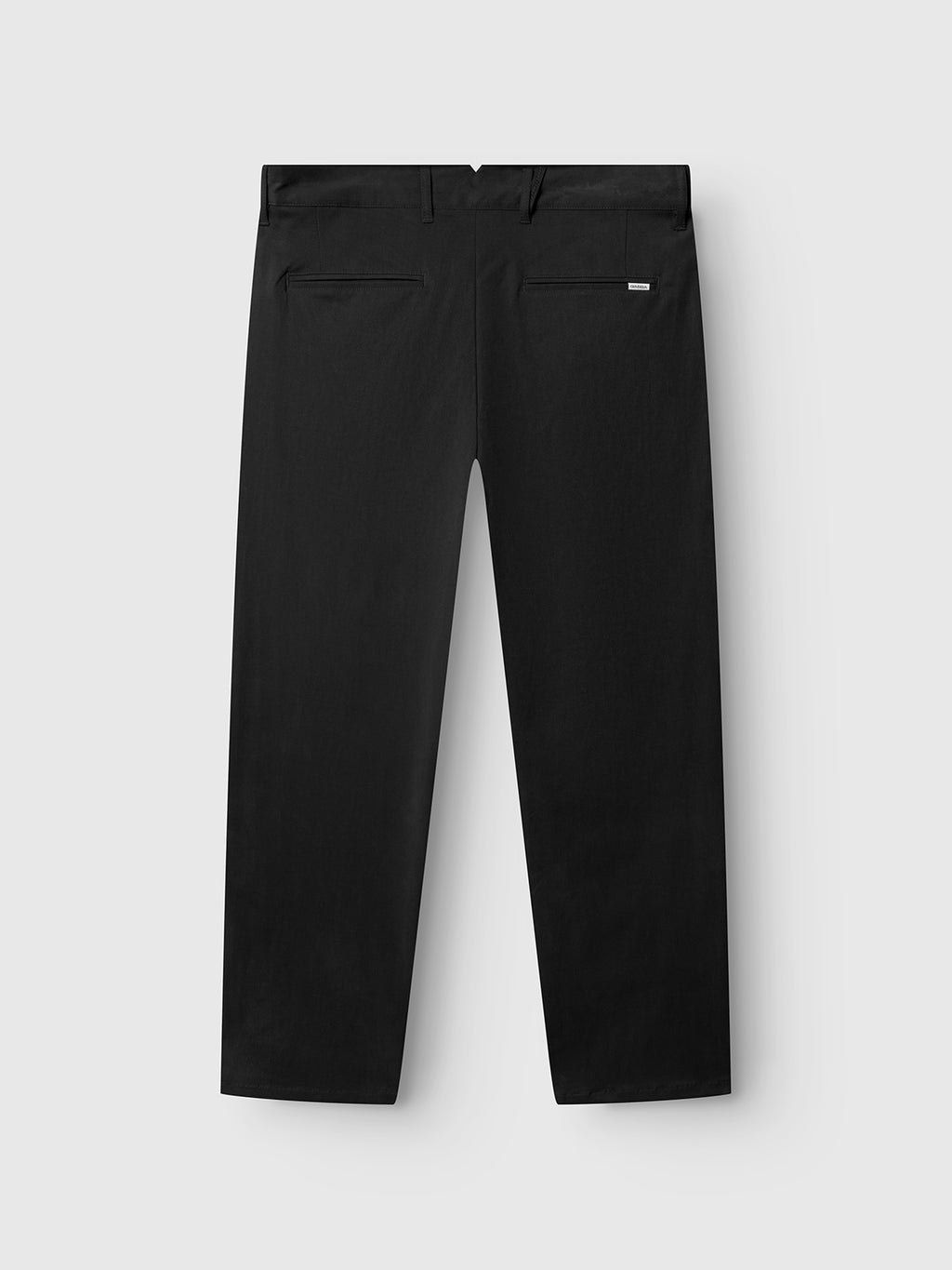 The GABfirenze Bolu Cropped TENCEL™ Pant by Gabba is displayed from the back, highlighting two rear pockets and a subtle brand tag above the right pocket. Made from stretch twill for enhanced comfort and flexibility, these black pants are laid flat on a light gray background.