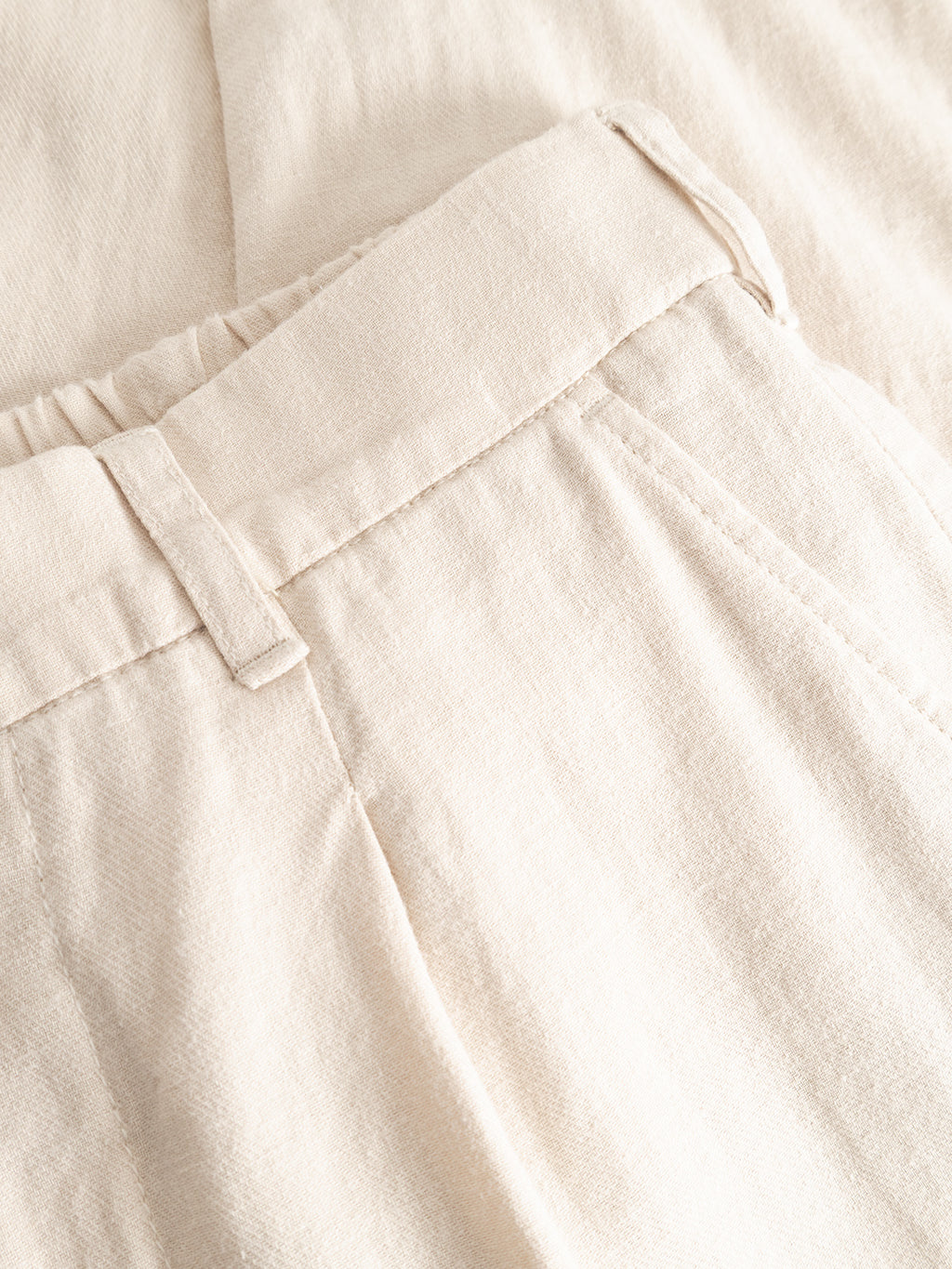Close-up of Gabba's GABnapoli 19 Lino Pant in Birch, regular straight fit with an elastic waistband and side pockets, laid flat on a lightweight fabric background.