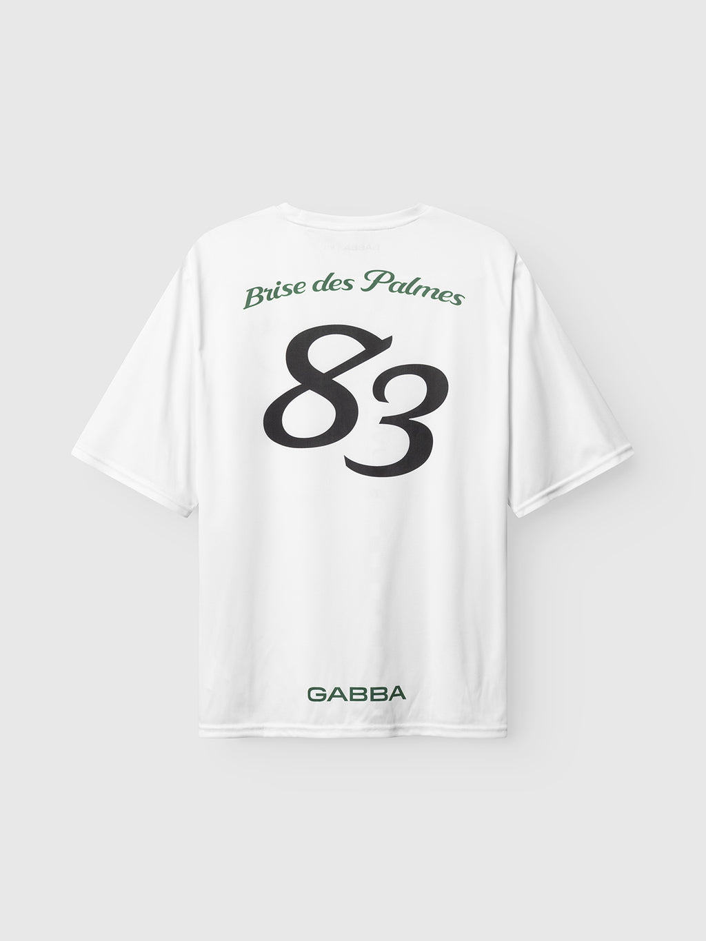 The Gabba GABnigel Fut Boxy Pes SS T-shirt in white features “Brise des Palmes” in green at the top back, a bold black 83 in the center, and “GABBA” in green below—a standout oversized piece from Gabba.