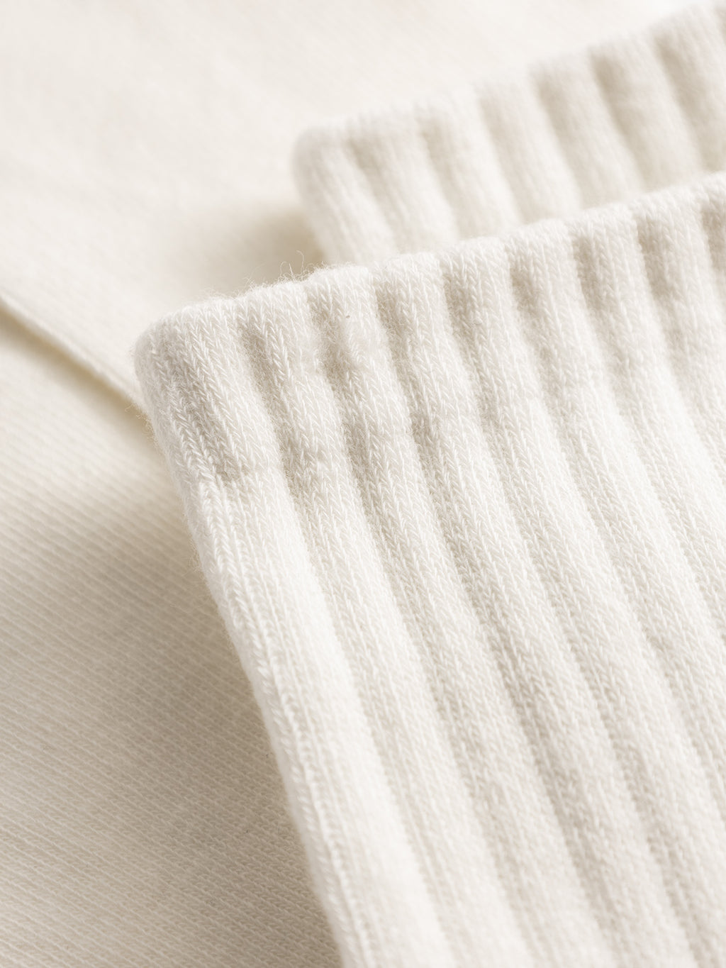 Close-up of the white ribbed knit fabric on GABbrise Socks by Gabba, showcasing the detailed texture typical of cozy and sporty cotton blend socks.