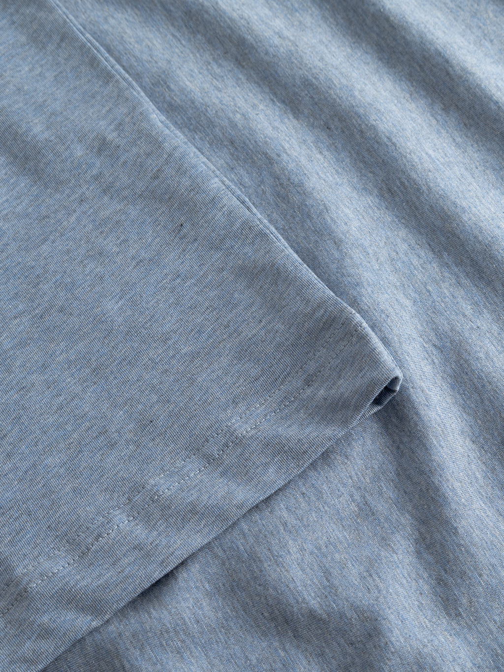 Close-up of Gabba's GABdune Melange New SS T-Shirt in Blue Melange, highlighting the soft, smooth jersey fabric with visible seam and stitching details.