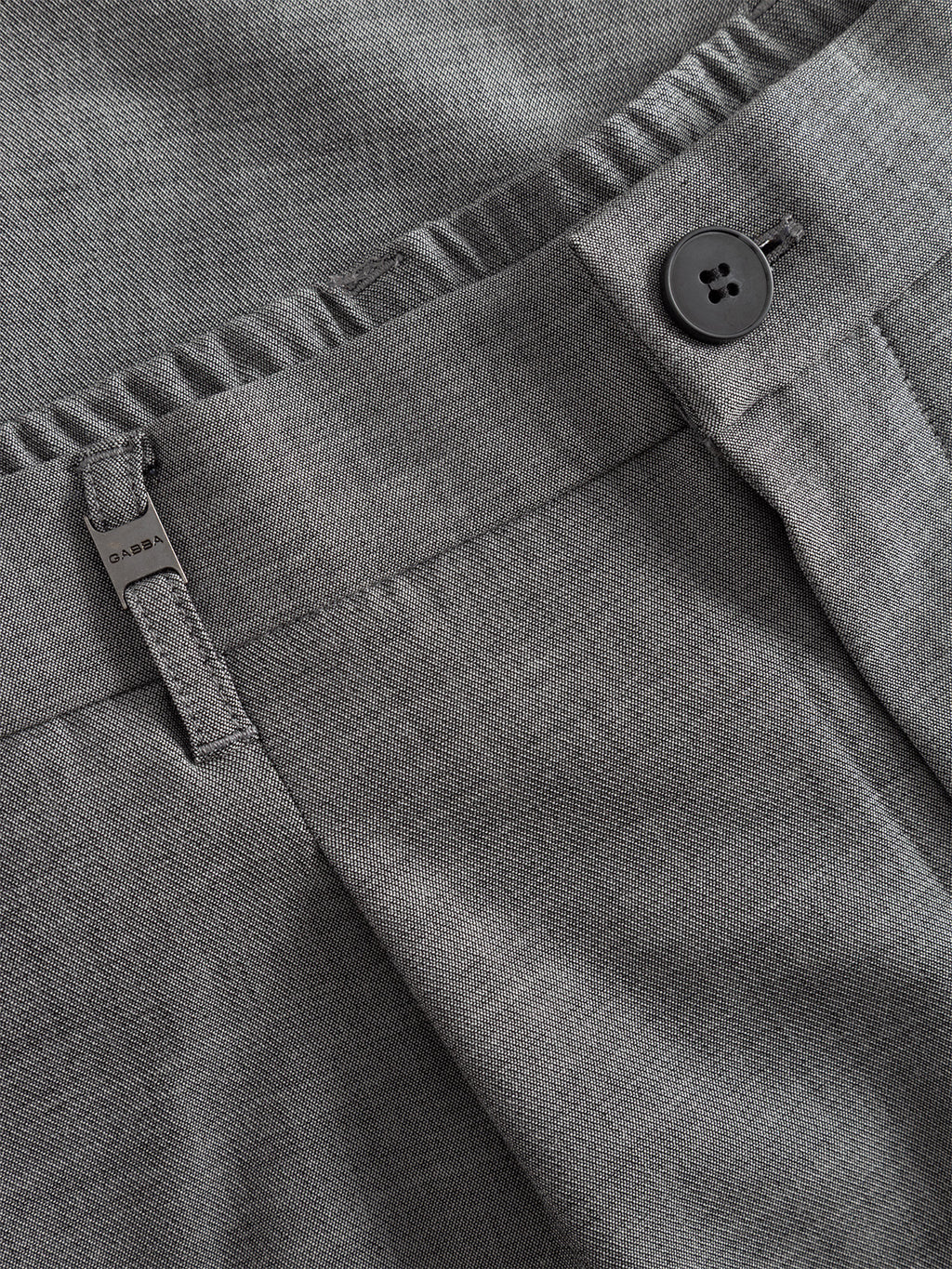Close-up of Gabba GABnapoli 19 Phin GRS - Lt. Grey wool-blend chinos in a regular straight fit, showing waistband, black button, belt loop, and zipper fly—crafted with recycled polyester and detailed stitching.
