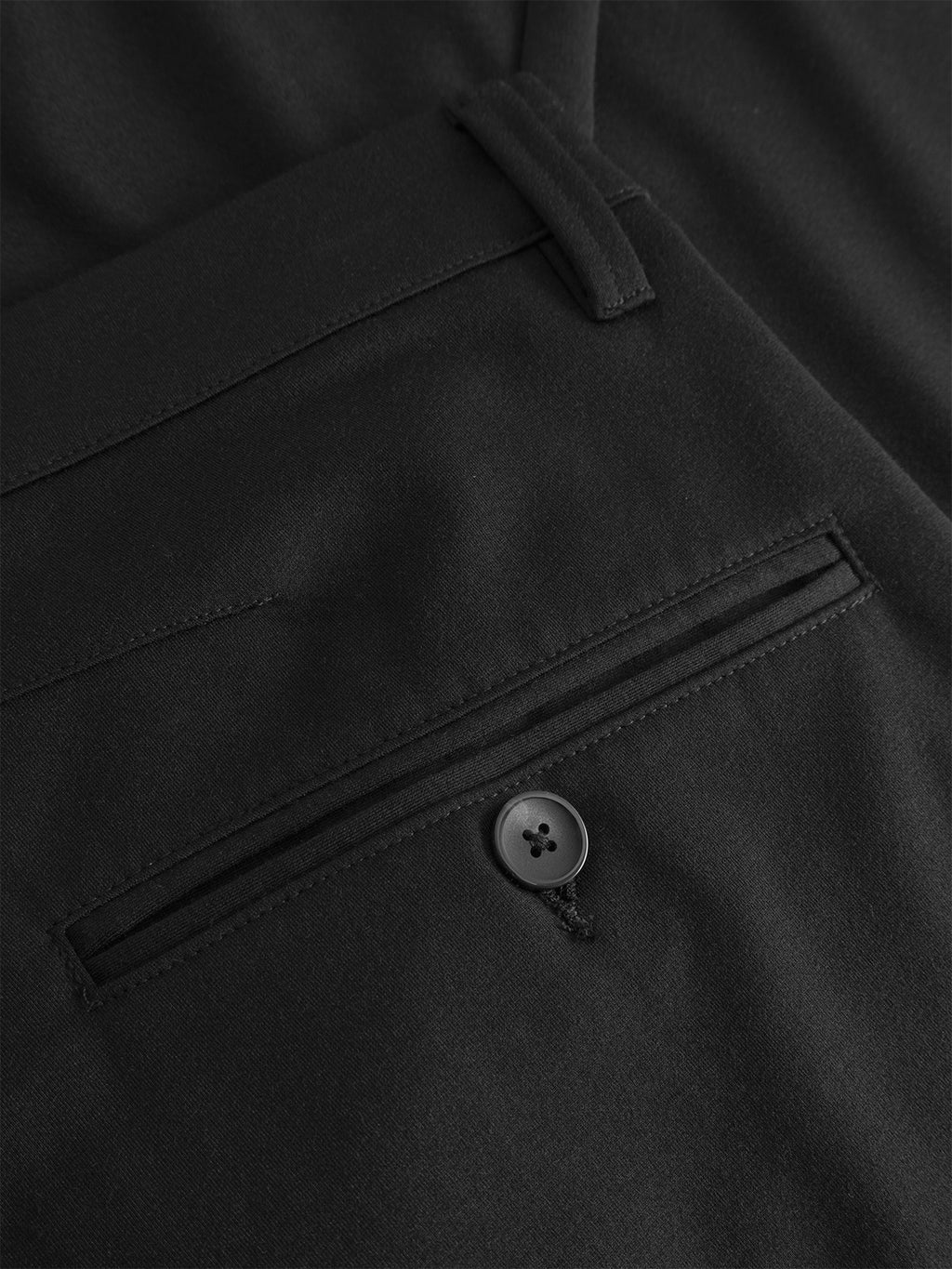 Close-up of the back pocket on Gabba's GABpaul Nygo - Black slim straight fit trousers, made from a soft-touch viscose blend for comfort and stretch, with a single black button fastening and belt loop detail.