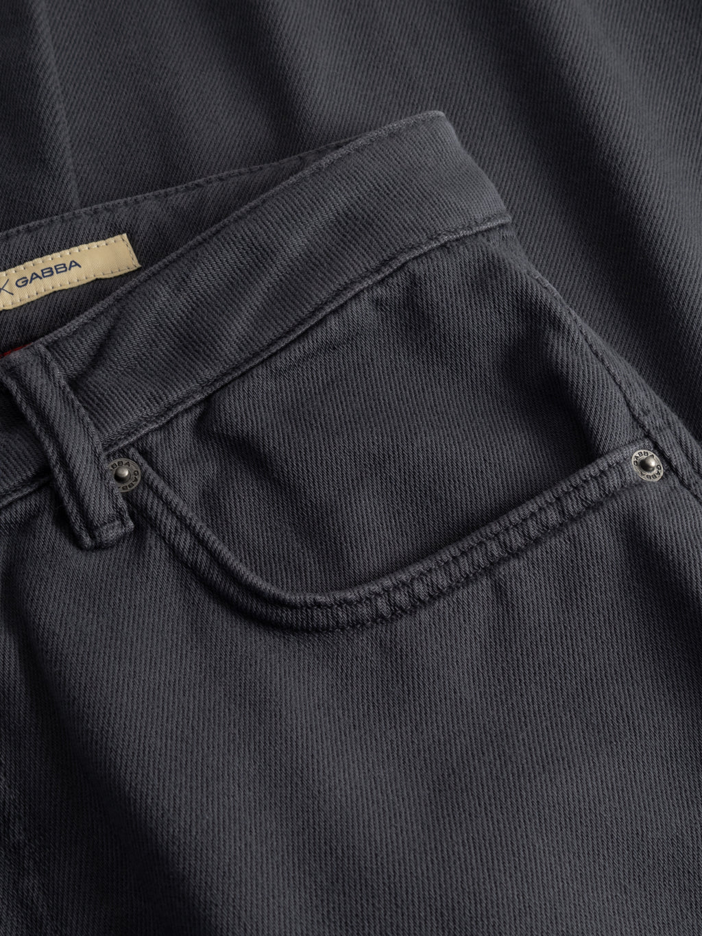 Close-up of Gabba GABcarl Blancel TENCEL™ Jeans - Black, highlighting the front pocket, stitching details, and part of the fabric label inside the waistband.