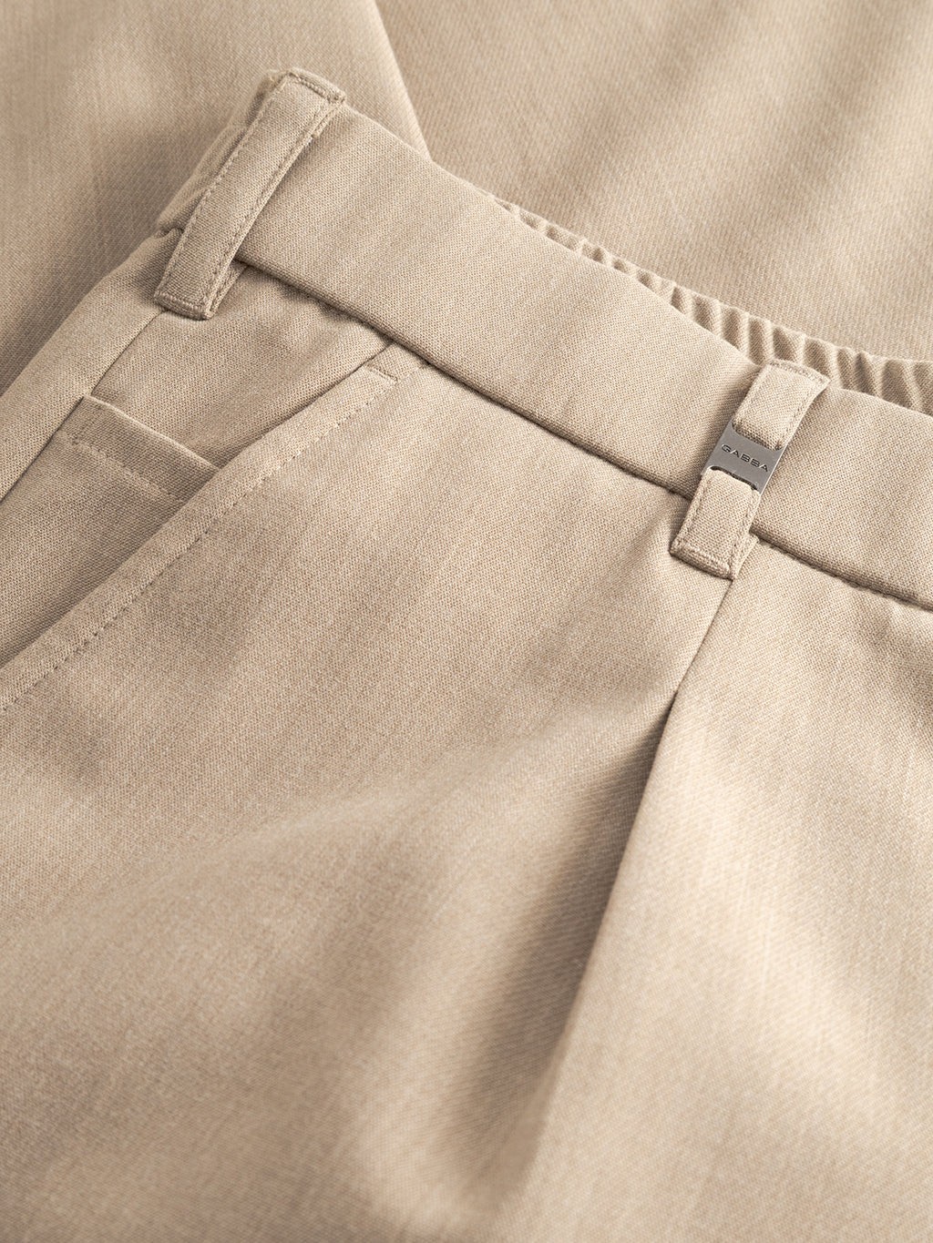 Close-up of Gabba GABnapoli 19 Phin GRS - Sand Plaza trousers, showing the waistband, belt loop, front pocket, and pleated detail. The regular straight fit highlights the textured stitching of the beige wool blend fabric.