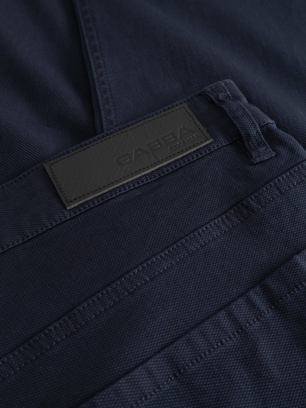 Close-up of Gabba GABmarc 5poc Marlo jeans in dark navy with a black rectangular leather label near the waistband, embossed with 