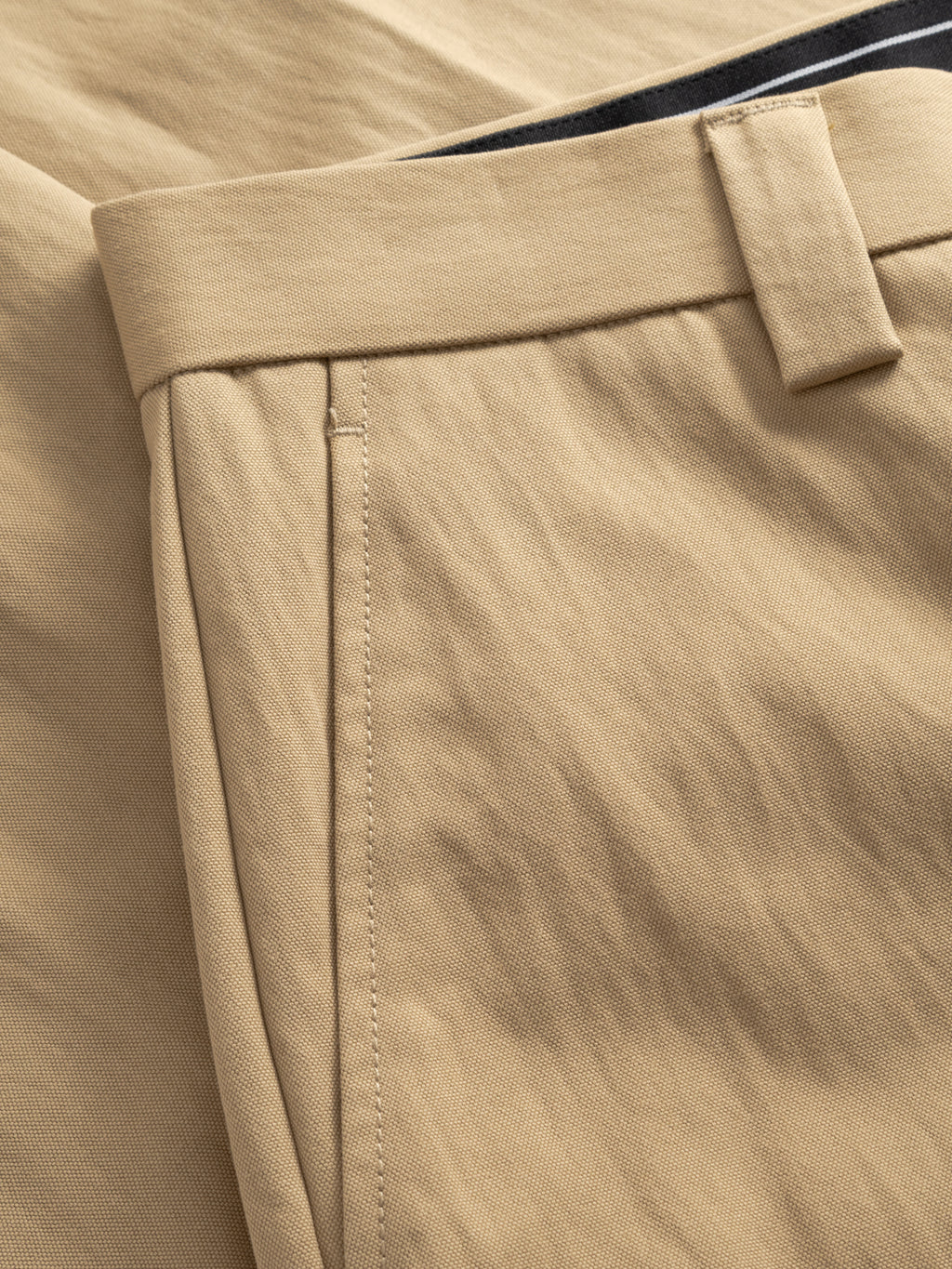 Close-up of the Gabba GABdenver Fuggies Pant in Sand, highlighting its workwear-inspired loose fit, detailed waistband, belt loop, and side pocket stitching on durable, textured fabric.
