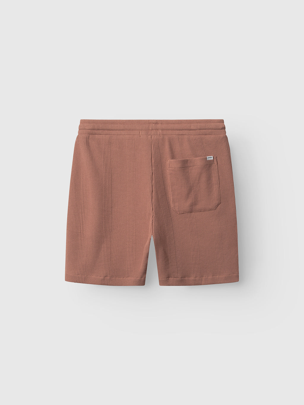 Gabba GABtommi Wup Shorts in Wood Pink shown flat on a light background, featuring a comfortable waistband and a single patch pocket on the back right side.
