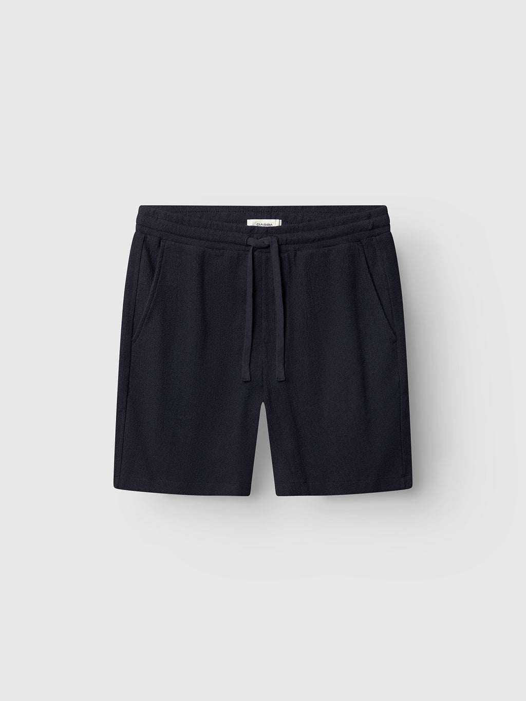 The Gabba GABtommi Towel Shorts in navy feature an elastic waistband, drawstring, and side pockets, shown against a light grey background.