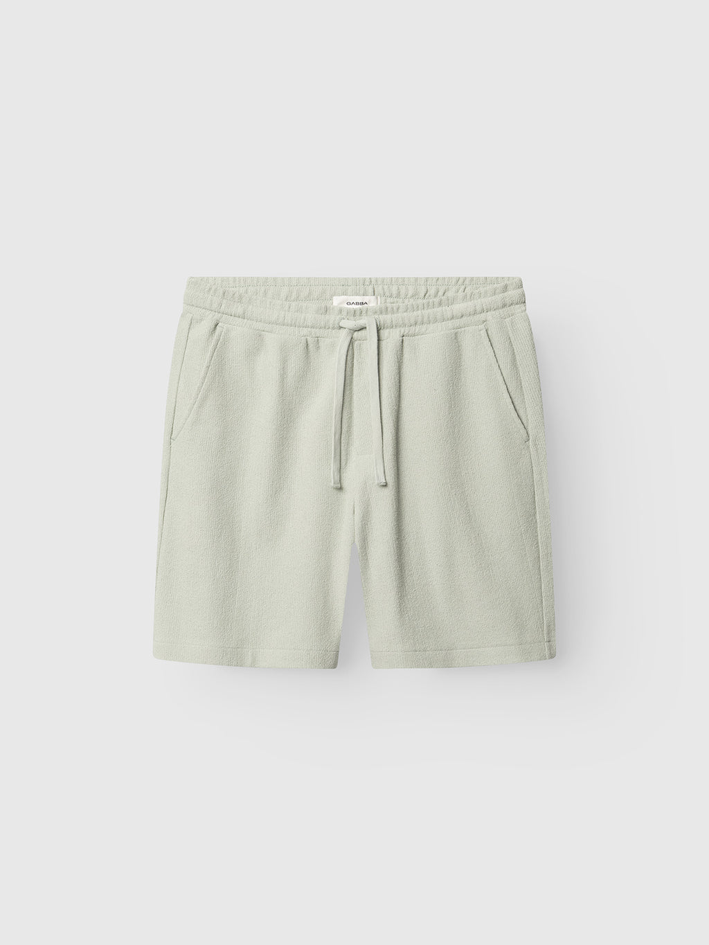 Gabba GABtommi Towel Shorts in Mineral Gray, featuring an elastic waistband, drawstring, and side pockets, shown on a plain white background.