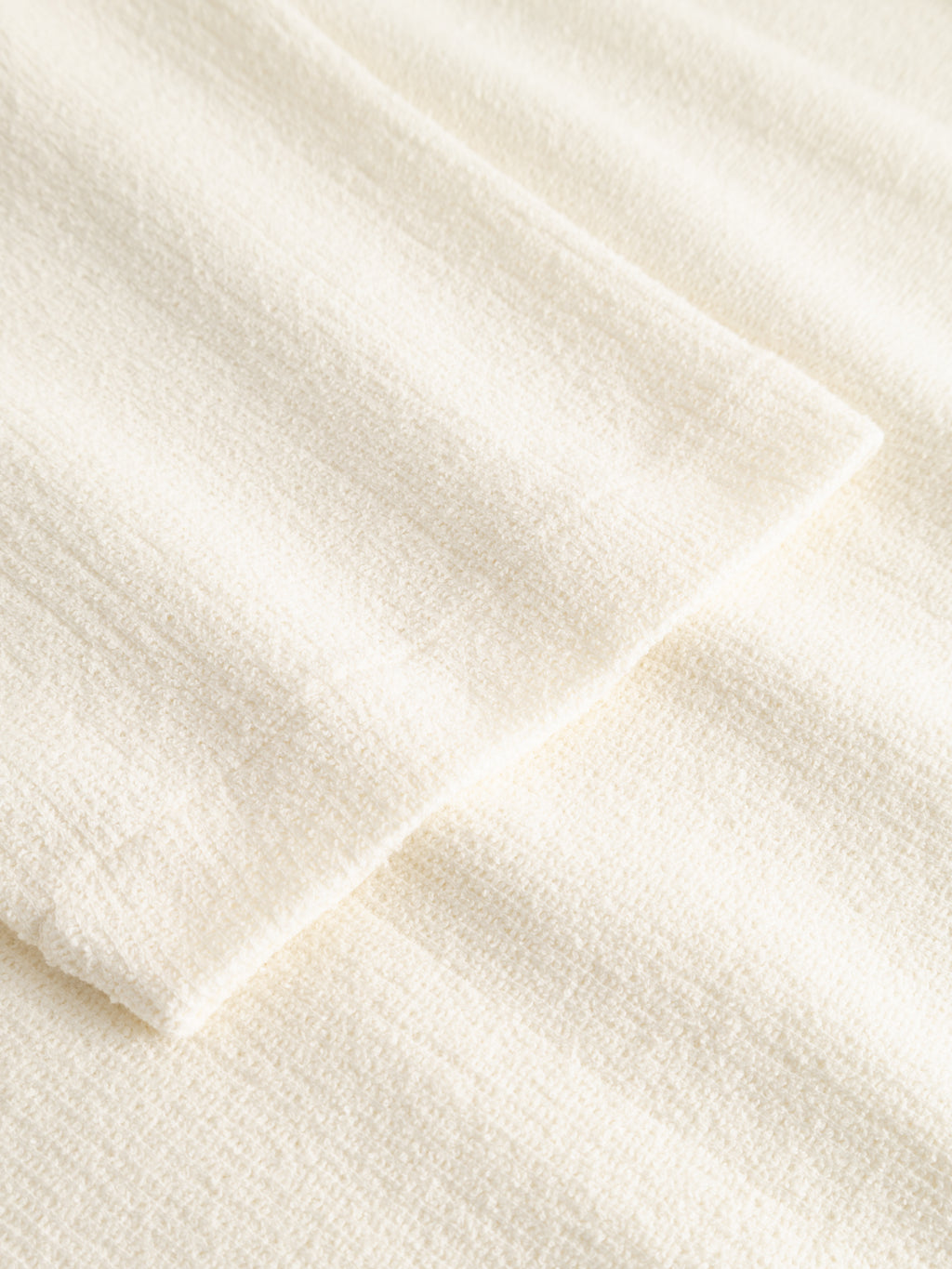 Close-up of Gabba's GABlio Sku Towel T-Shirt in Egret, featuring soft, textured white fabric with overlapping layers and a subtle woven pattern—evoking the plush comfort of cozy terry cotton.