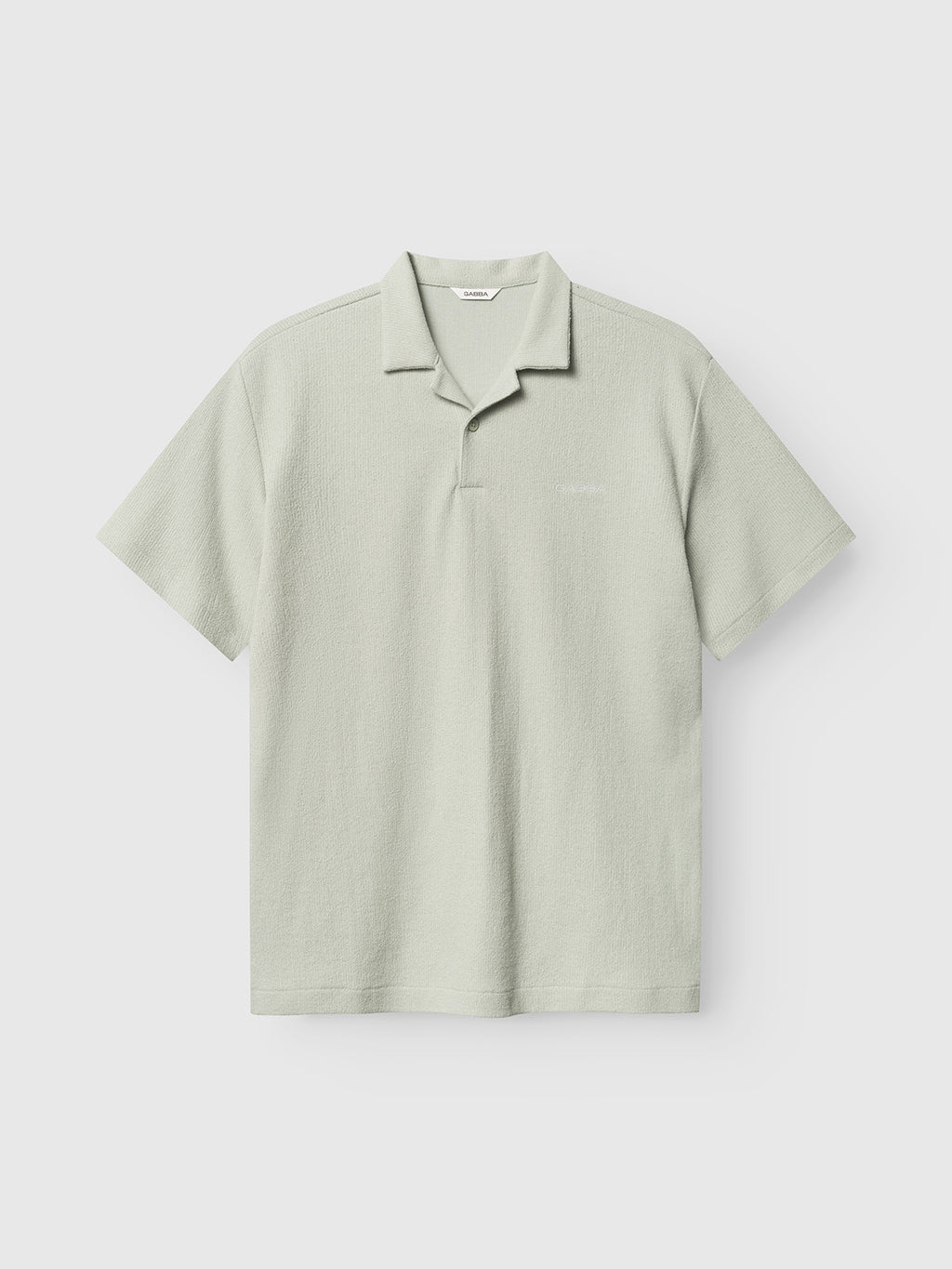 The Gabba GABlio Sku Towel T-Shirt in Mineral Gray features a regular fit, crafted from a soft terry cotton blend with a subtle polo collar and short sleeves, shown against a plain white background.