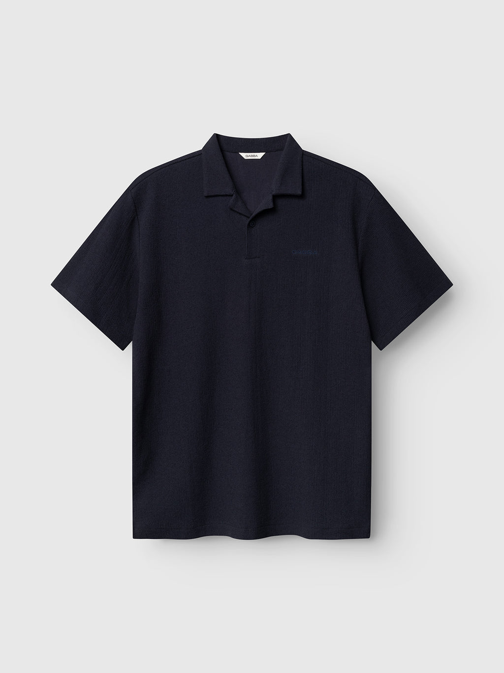 The Gabba GABlio Sku Towel T-Shirt in Night Sky is a short-sleeve, dark navy terry cotton tee with a relaxed fit and classic polo collar, shown on a plain light gray background.