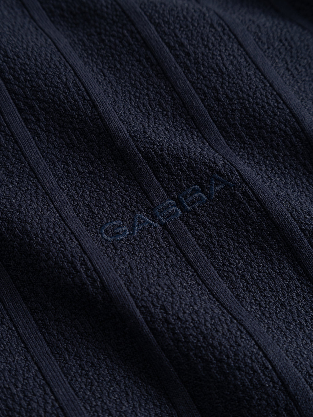 Close-up of the Gabba GABvalente Armor SS T-Shirt in navy shows its textured cotton-blend fabric with vertical stitched lines and 