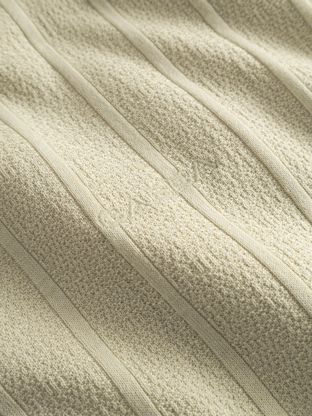 Close-up of the Gabba GABvalente Armor SS T-Shirt in Alfa Green, showing its textured cotton-blend fabric with vertical ribbed lines and a subtle central embroidered design. The material appears soft and woven.