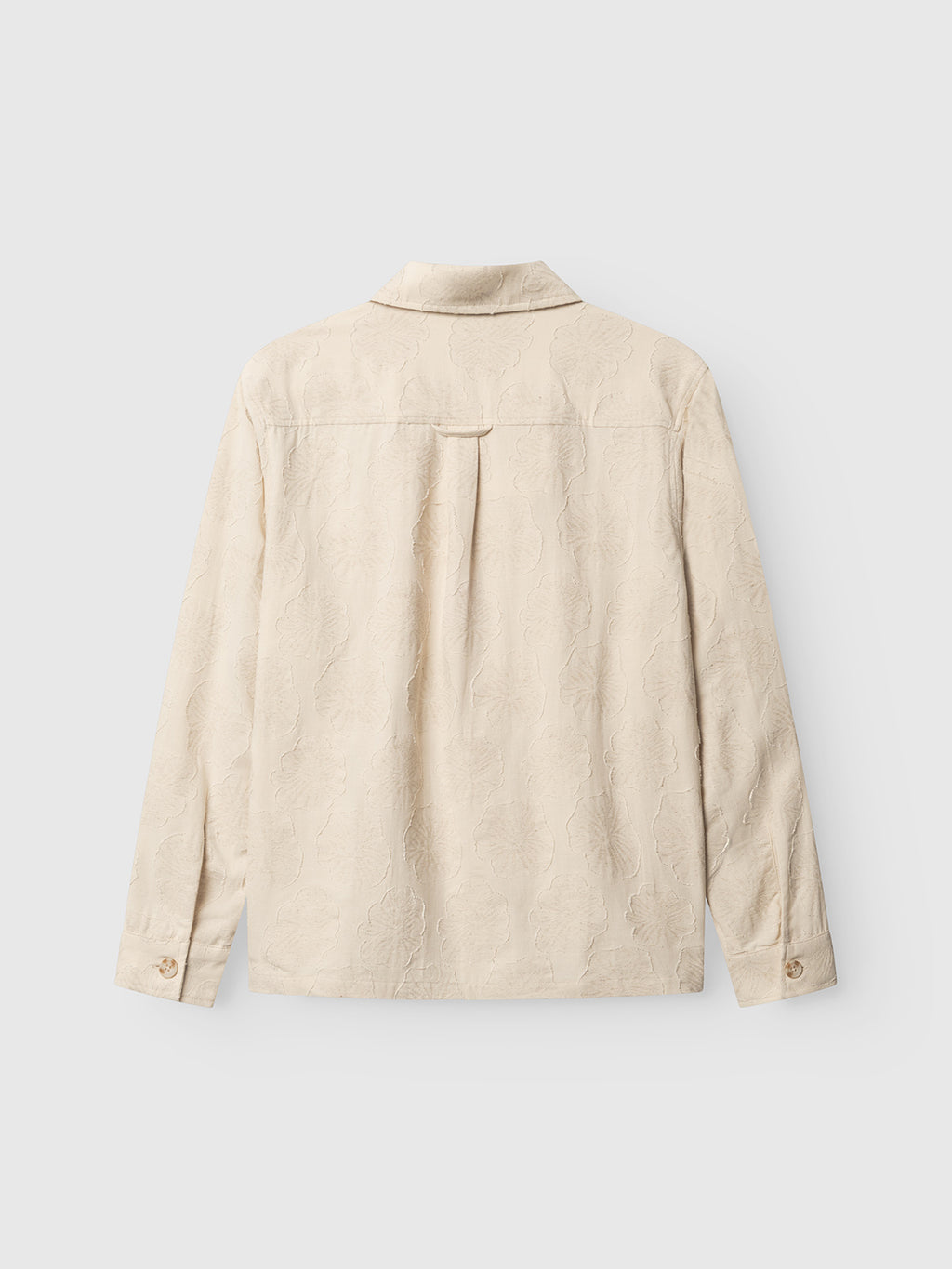 The GABaustin Reso Raw LS Overshirt by Gabba in Lt. Sand is a long-sleeved, jacquard-woven cotton overshirt with an embossed floral pattern, collar, back pleat, and buttoned cuffs, shown from the back.