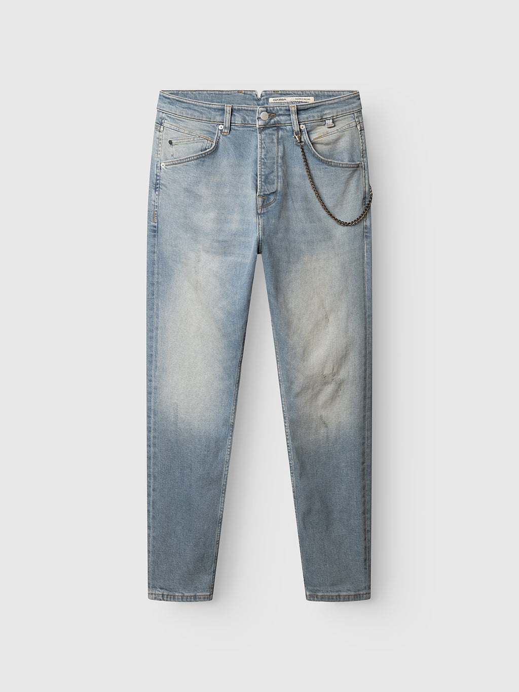 The GABalex Cros Cropped jeans by Gabba, crafted from contemporary light blue denim with a faded washed effect, feature a relaxed tapered silhouette, five-pocket design, and a silver chain attached to a belt loop. The jeans are displayed laid flat on a plain white background.