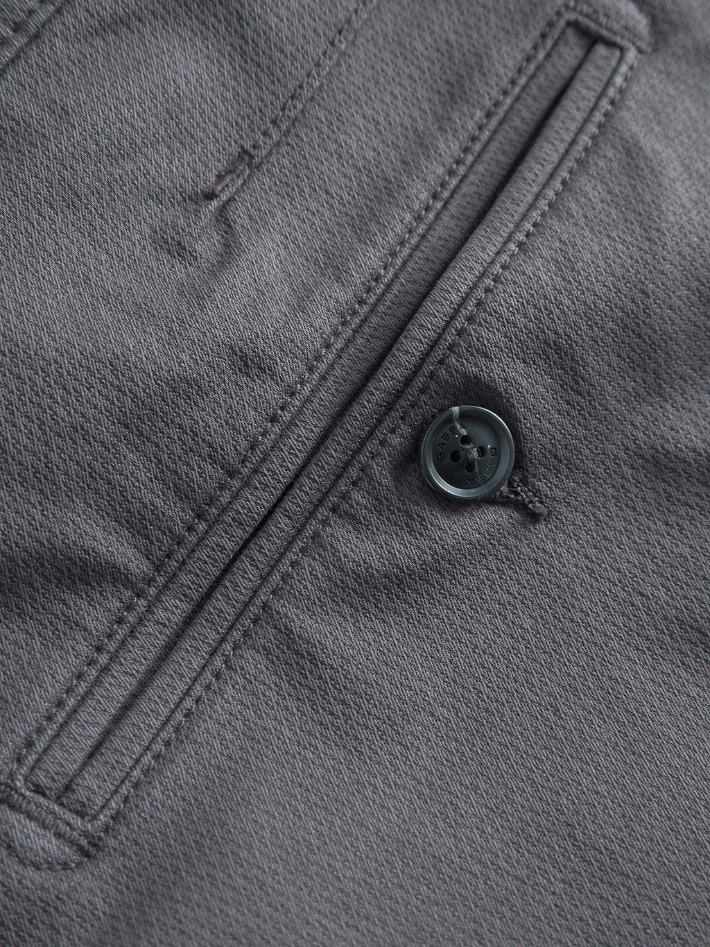 Close-up of Gabba GABpaul K3280 Dale Chino in Charcoal, featuring French pockets, a gray textured fabric, black button, and detailed stitching.