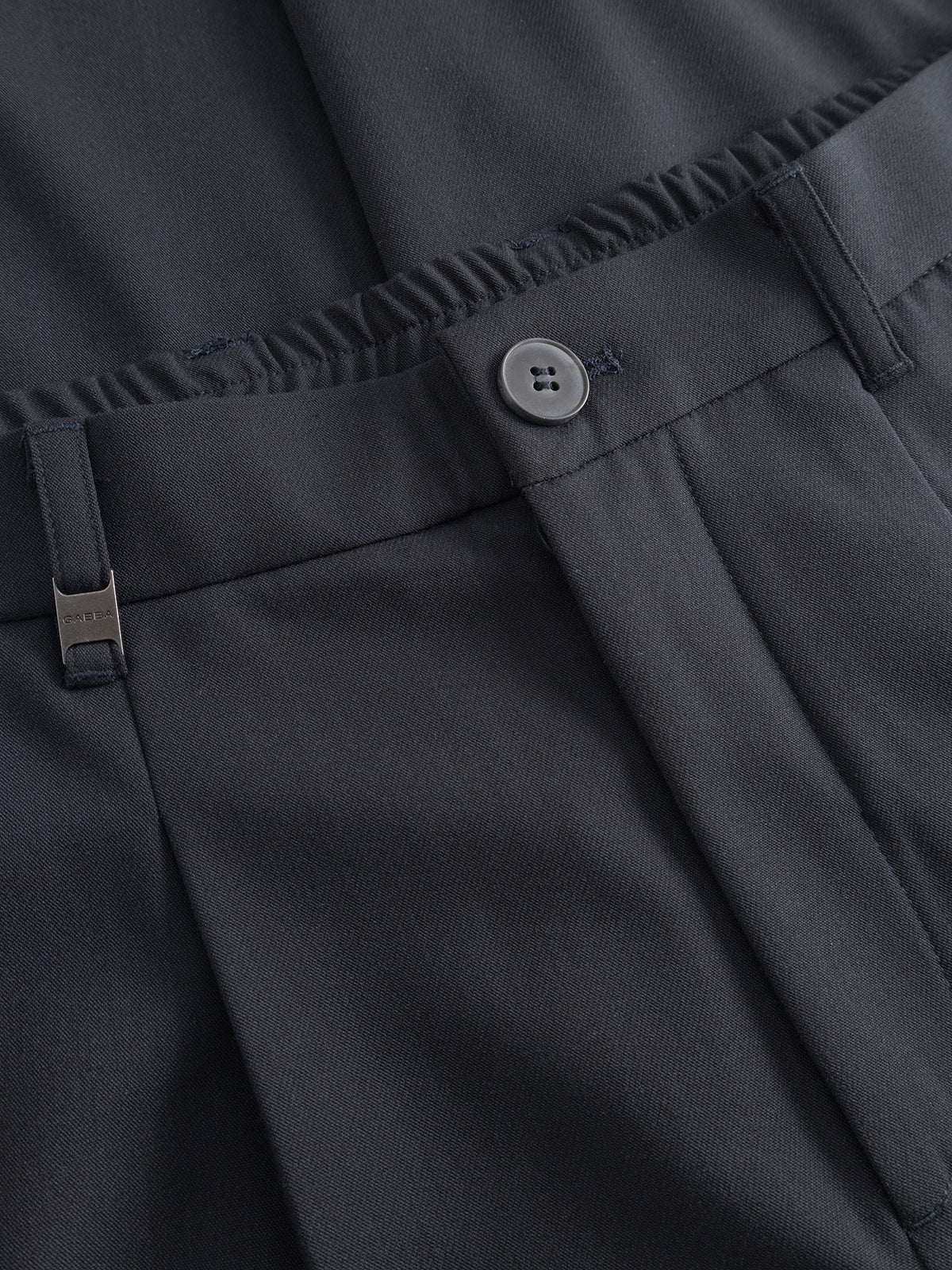 Close-up of Gabba GABnapoli 19 Phin GRS - Blue Black regular straight fit dress pants with button closure, back elastic waistband, and metal clip by the belt loop, crafted from a wool blend chino with recycled polyester for a smooth finish.